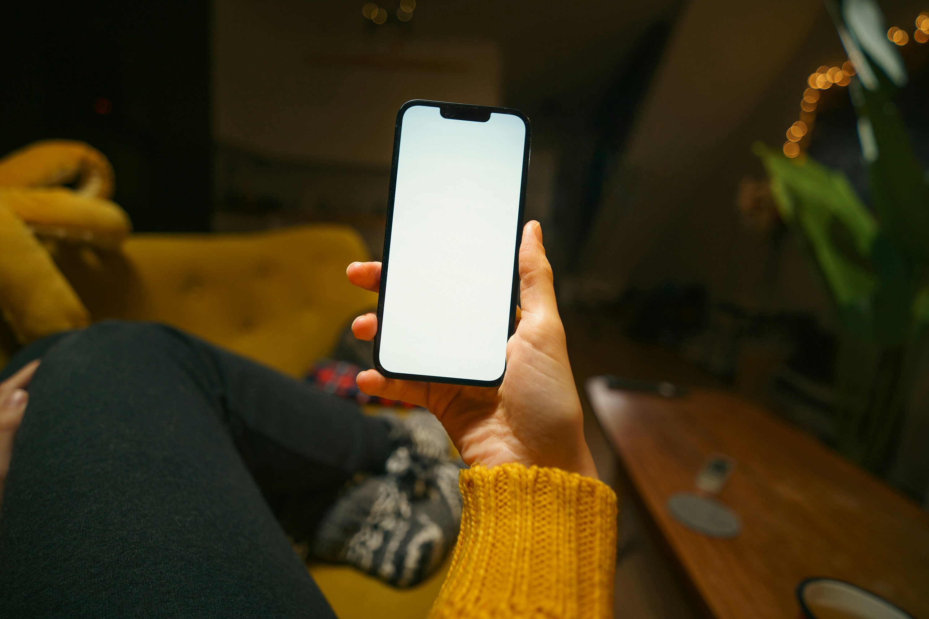 A person holding a cell phone in their hand