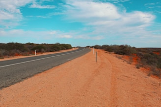 An empty road in the middle of the desert