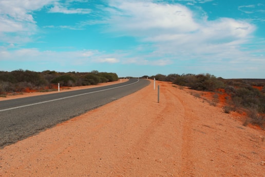 An empty road in the middle of the desert