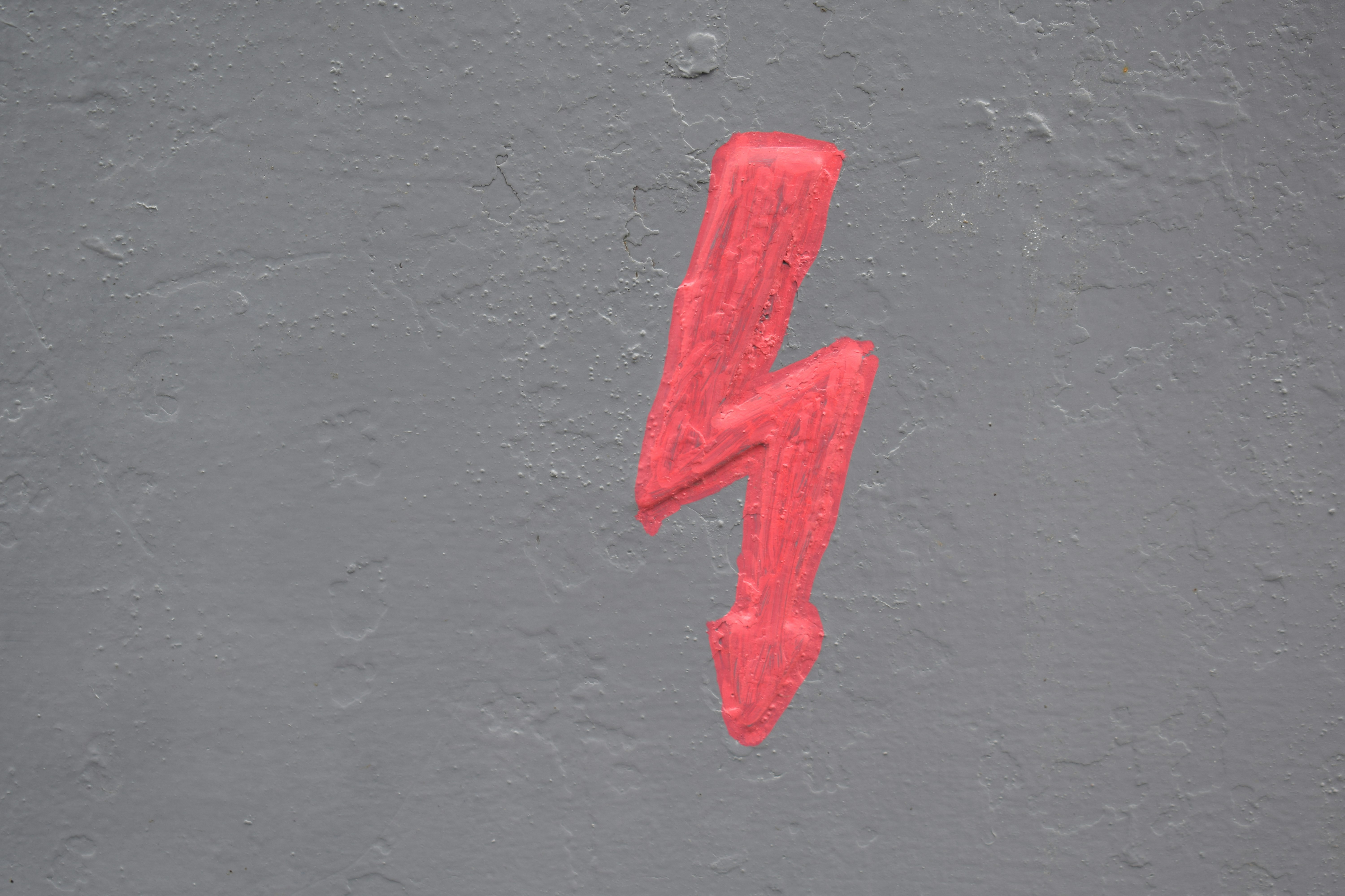 A red lightning bolt painted on the side of a building