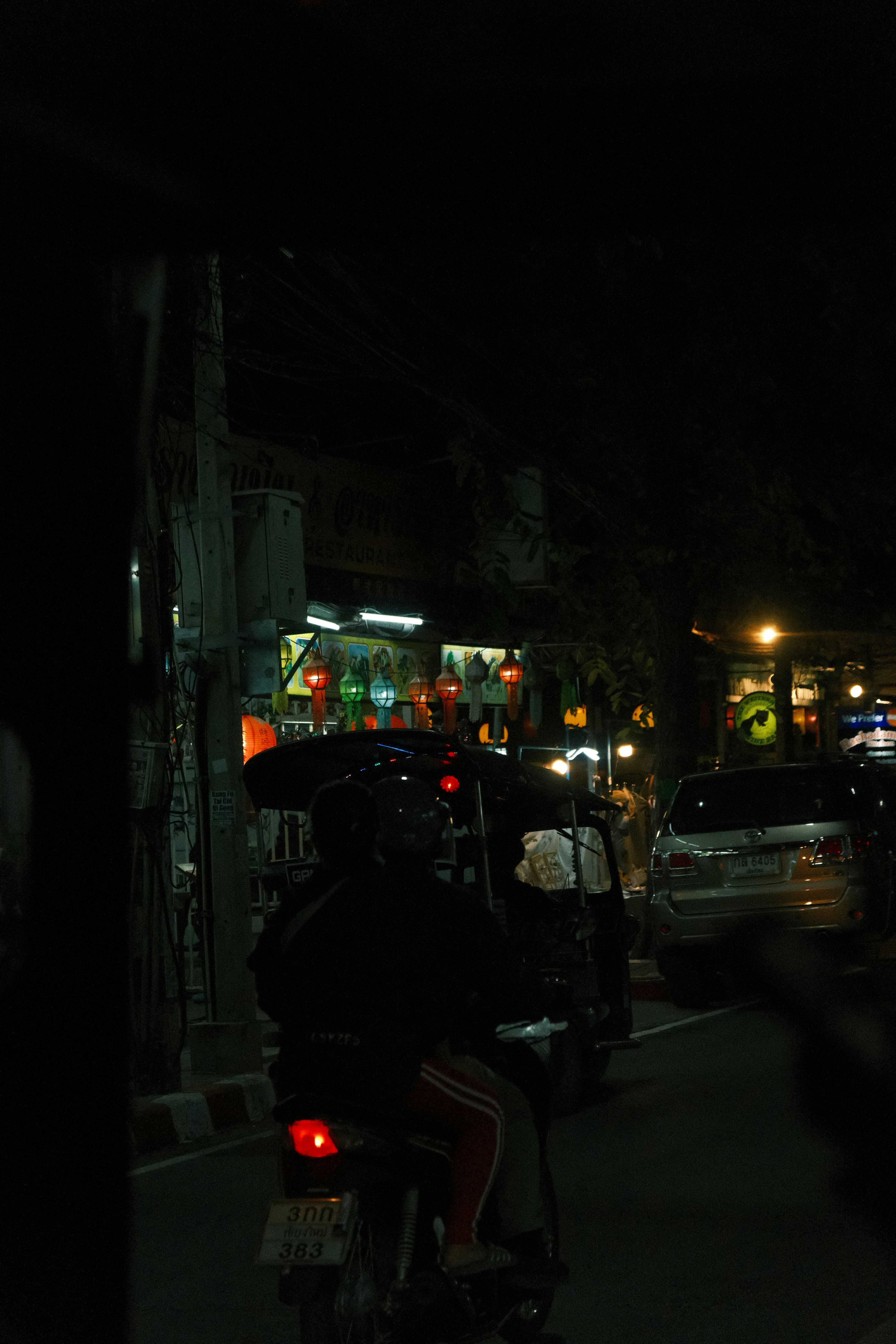 A motorcycle parked on the side of a road at night