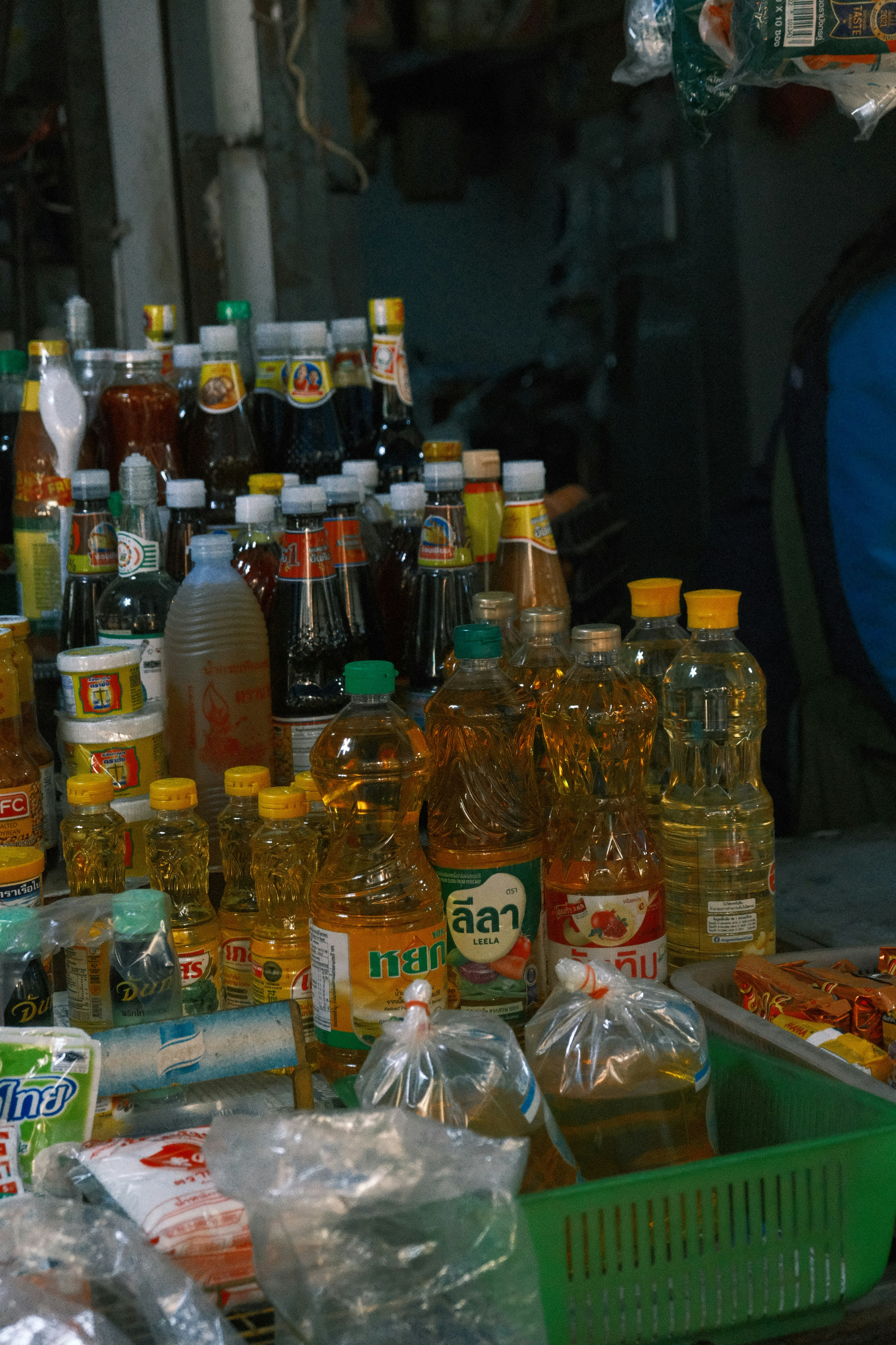 A man sitting in front of a table filled with bottles