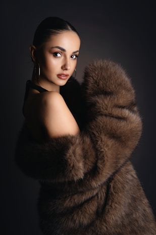 A woman in a fur coat posing for a picture