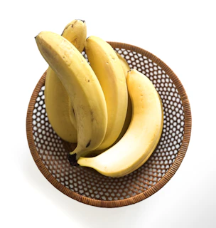 A bunch of bananas sitting on top of a brown plate