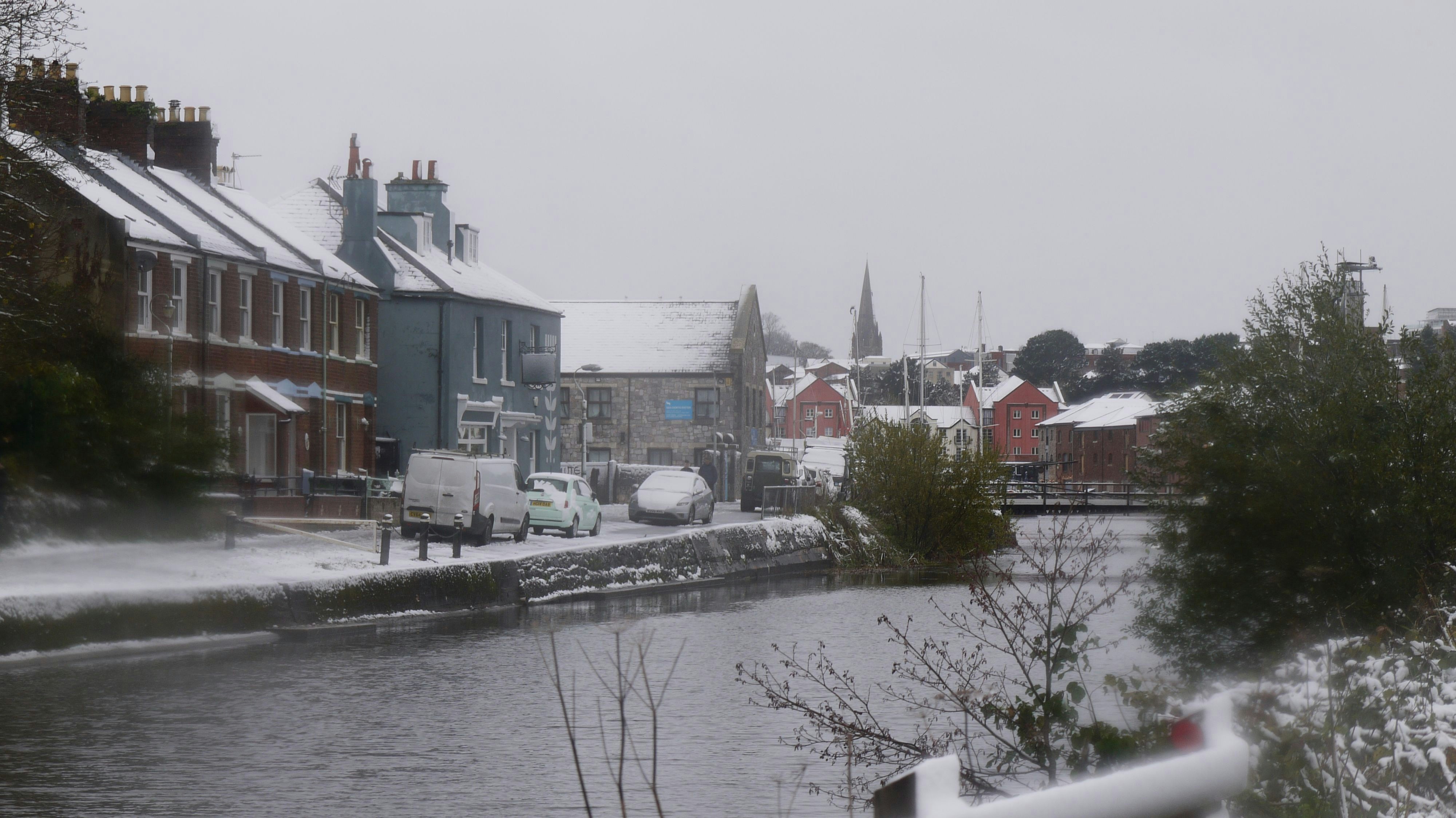 A river running through a small town covered in snow