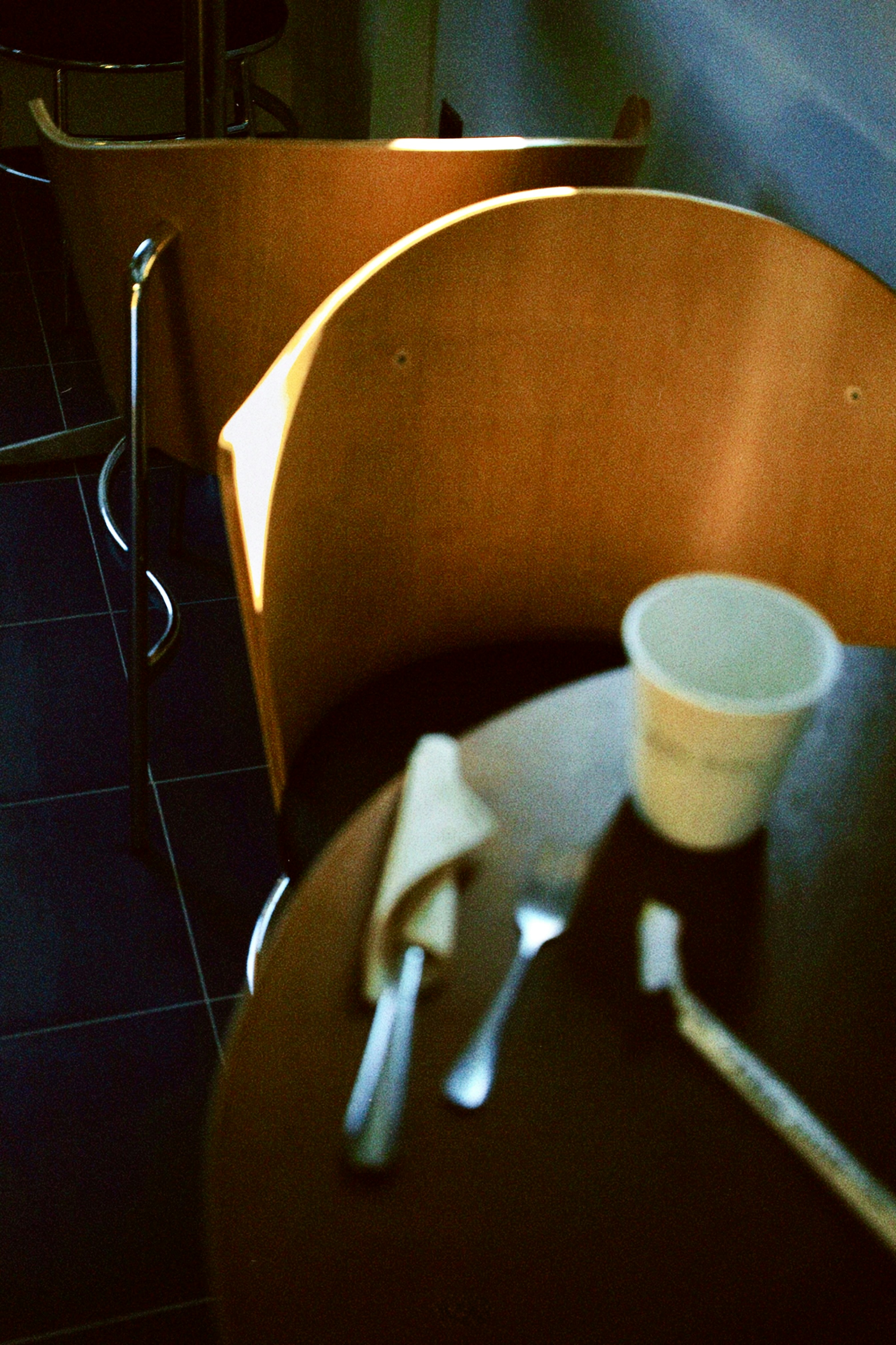 A wooden table topped with a cup of coffee