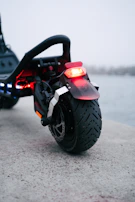 A close up of a motorcycle parked near a body of water