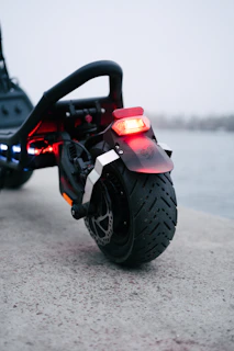 A close up of a motorcycle parked near a body of water