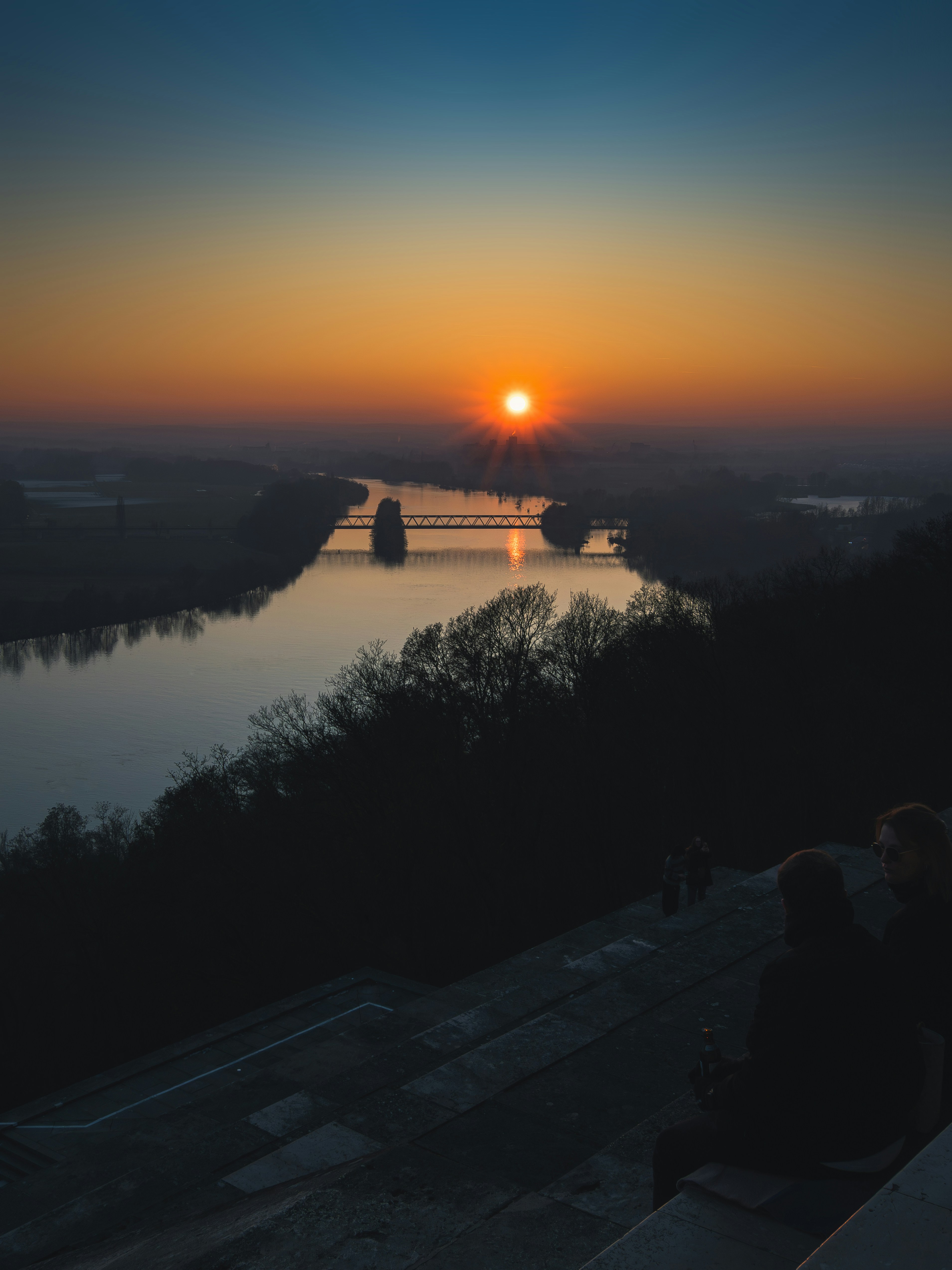 A couple of people sitting on top of a roof