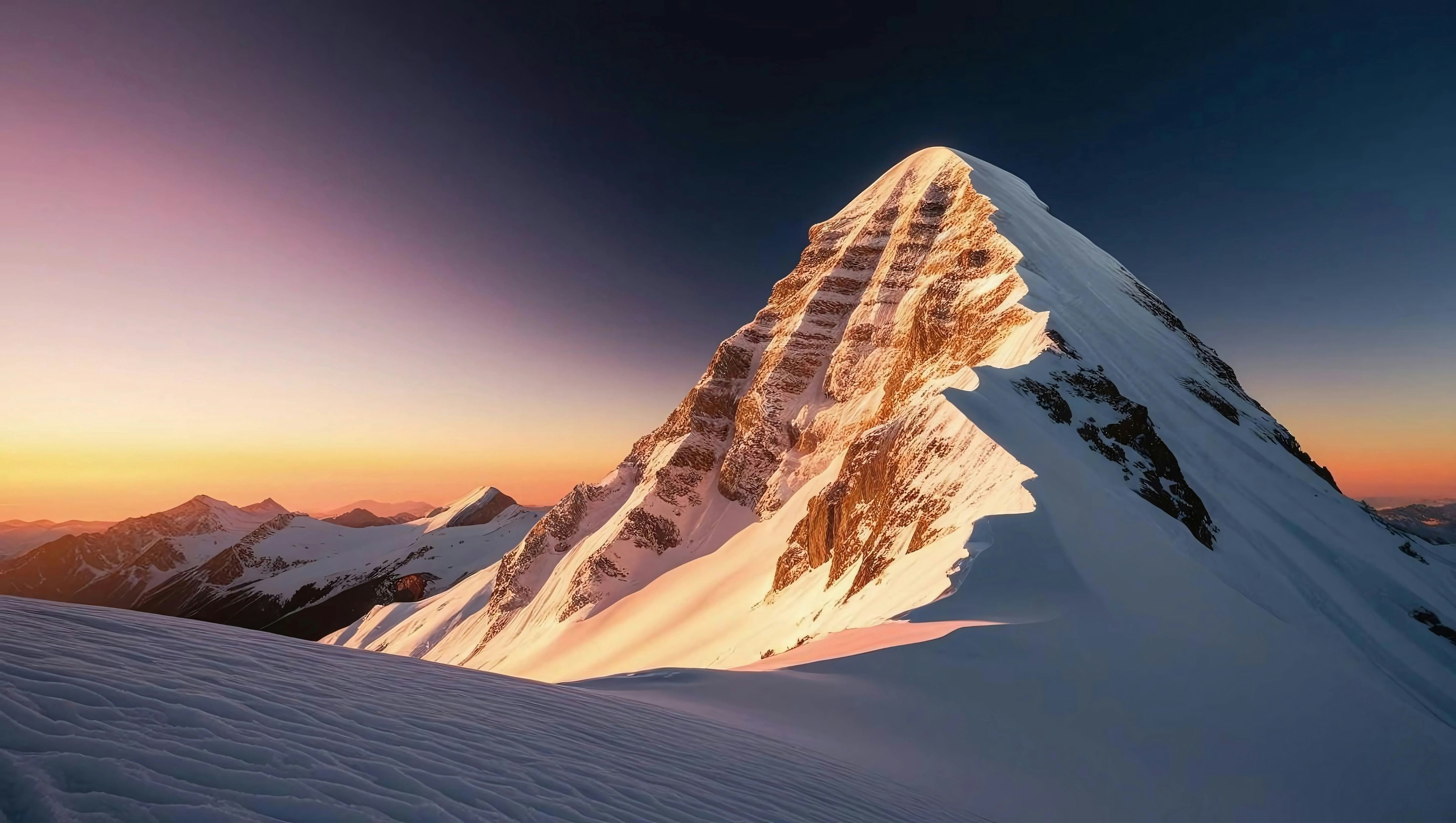 A mountain covered in snow with a sunset in the background