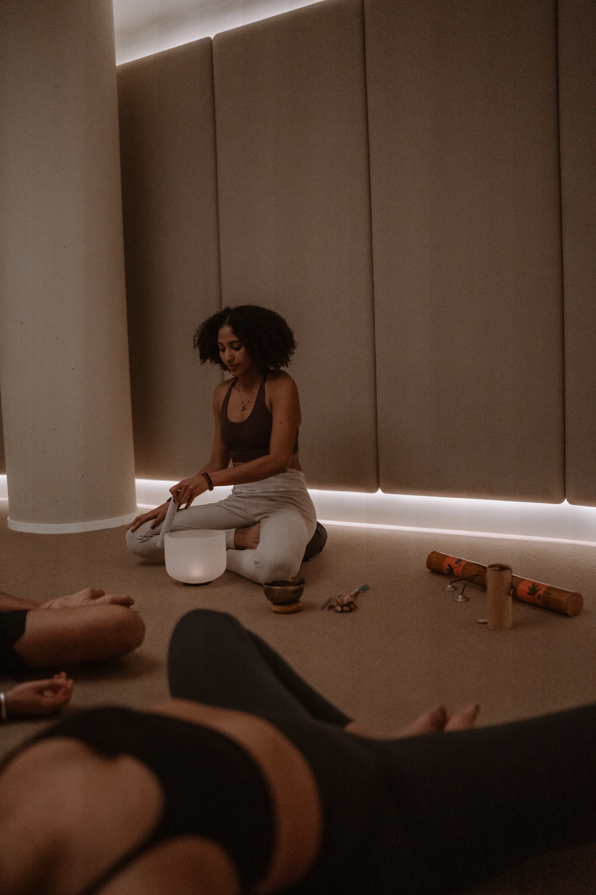 A group of people sitting on the floor in a room