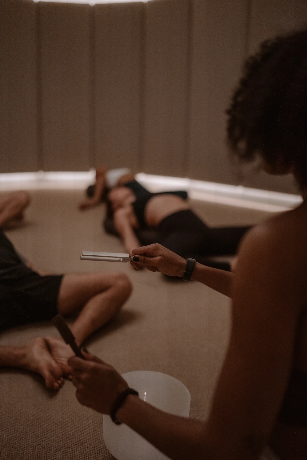 A group of people sitting on the floor in a circle