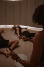 A group of people sitting on the floor in a circle