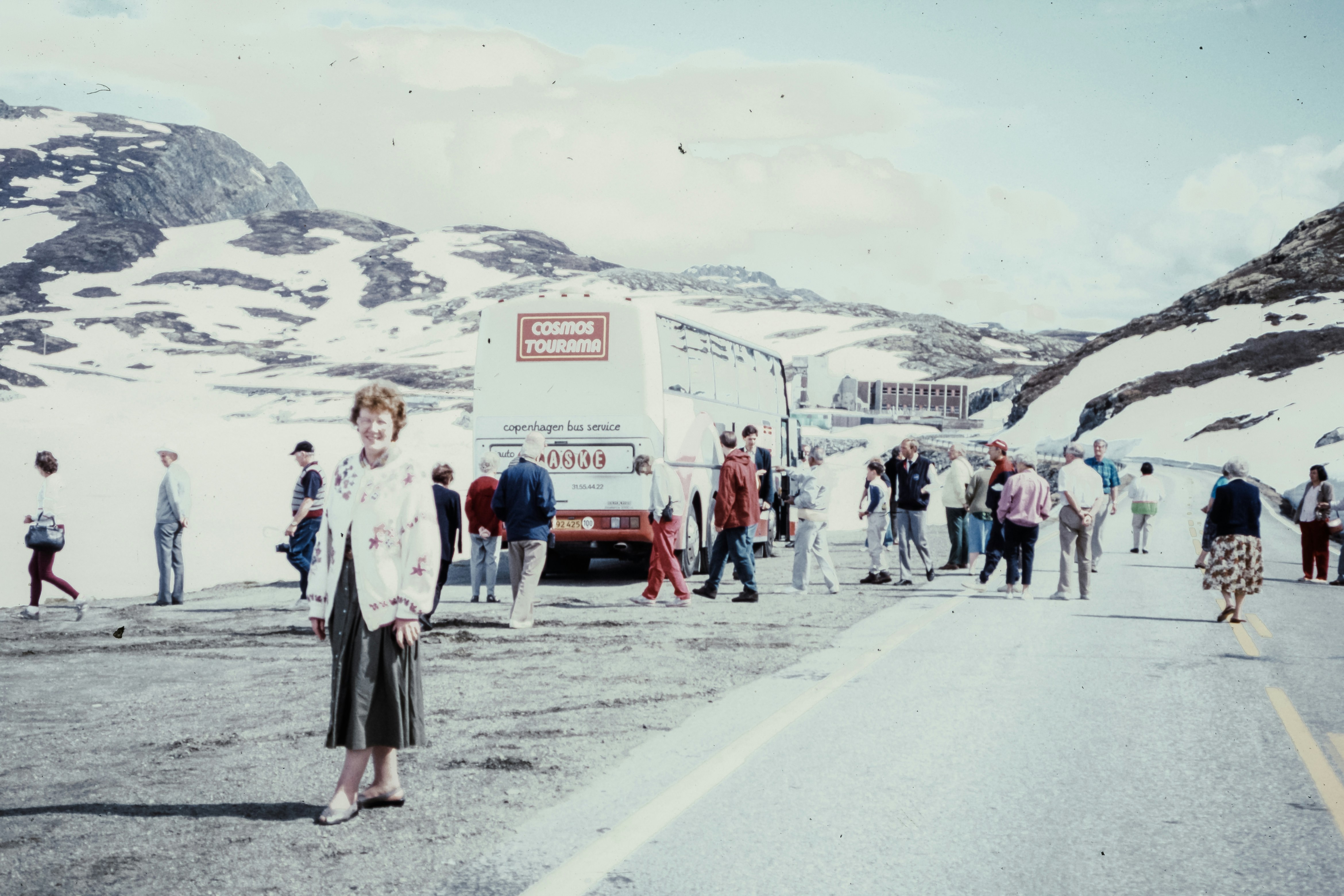 A group of people standing on the side of a road