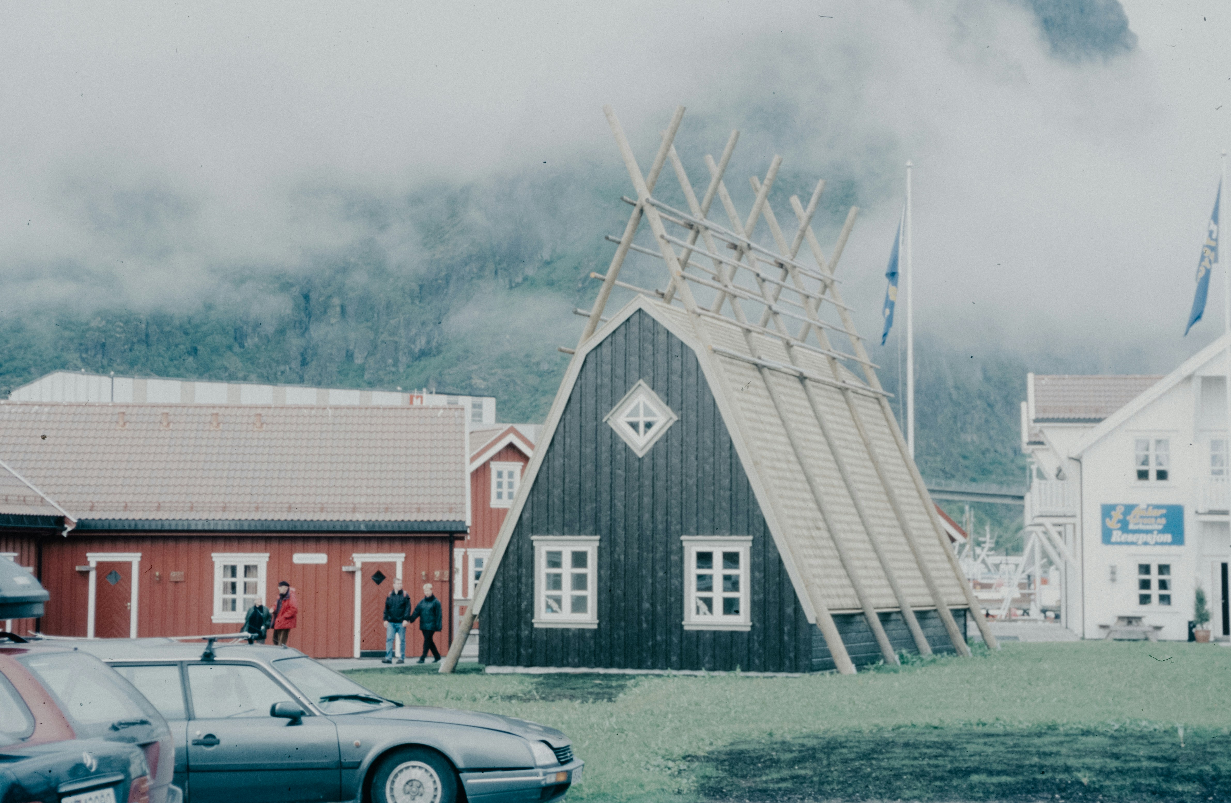 A car is parked in front of a barn