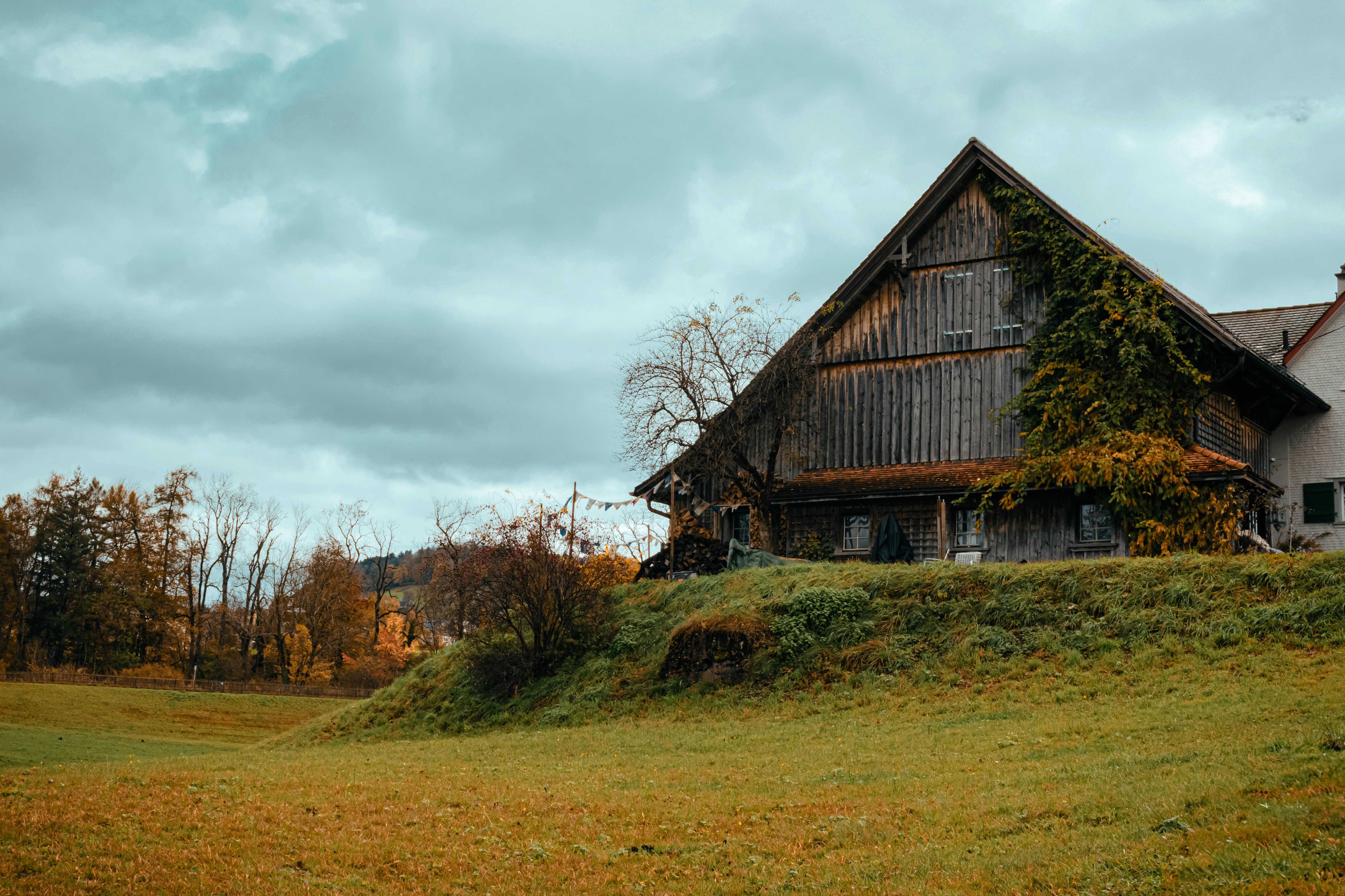 A large house sitting on top of a lush green hillside