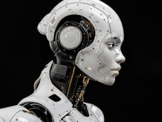 A white robot is standing in front of a black background