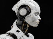 A white robot is standing in front of a black background
