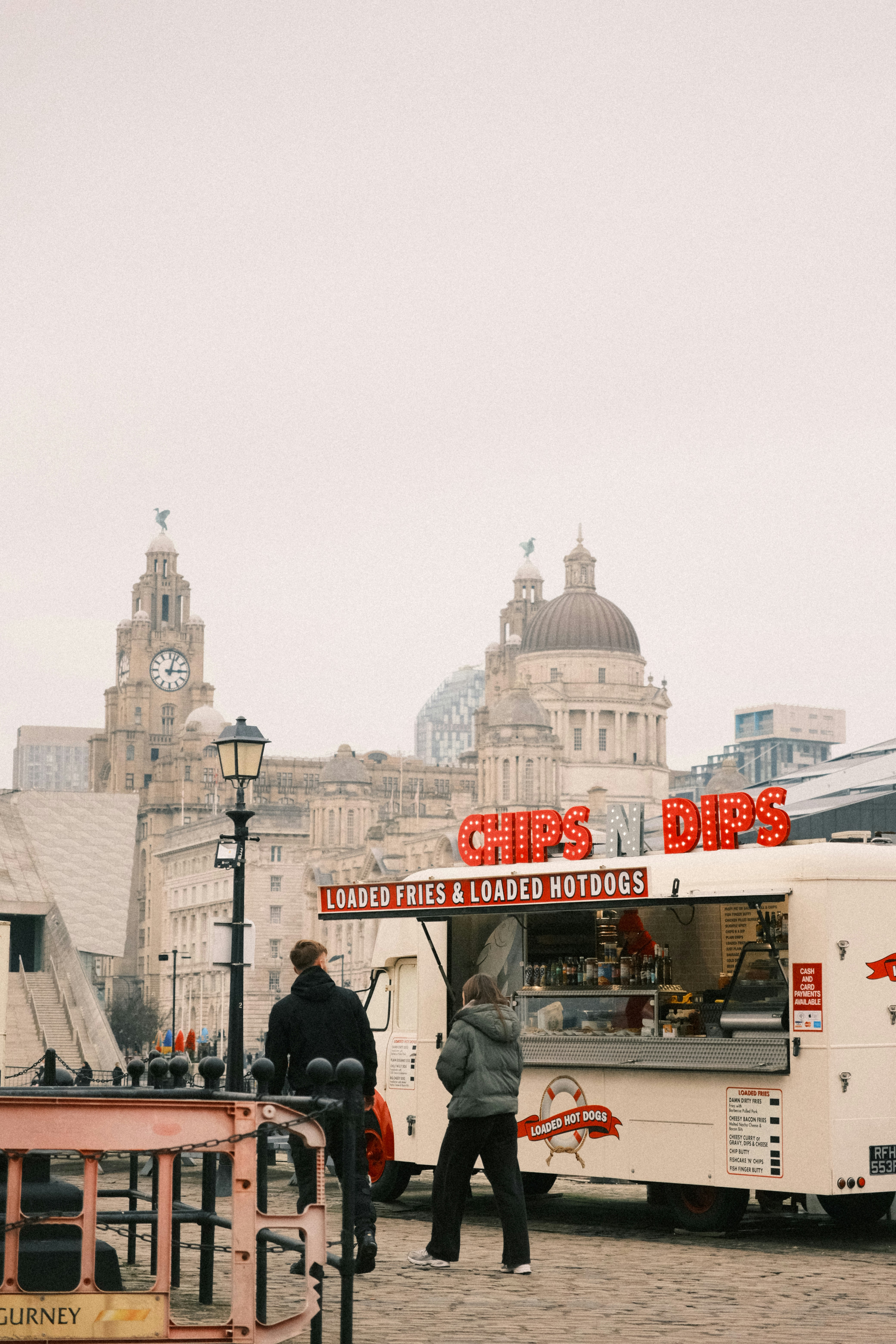 A group of people standing around a food truck