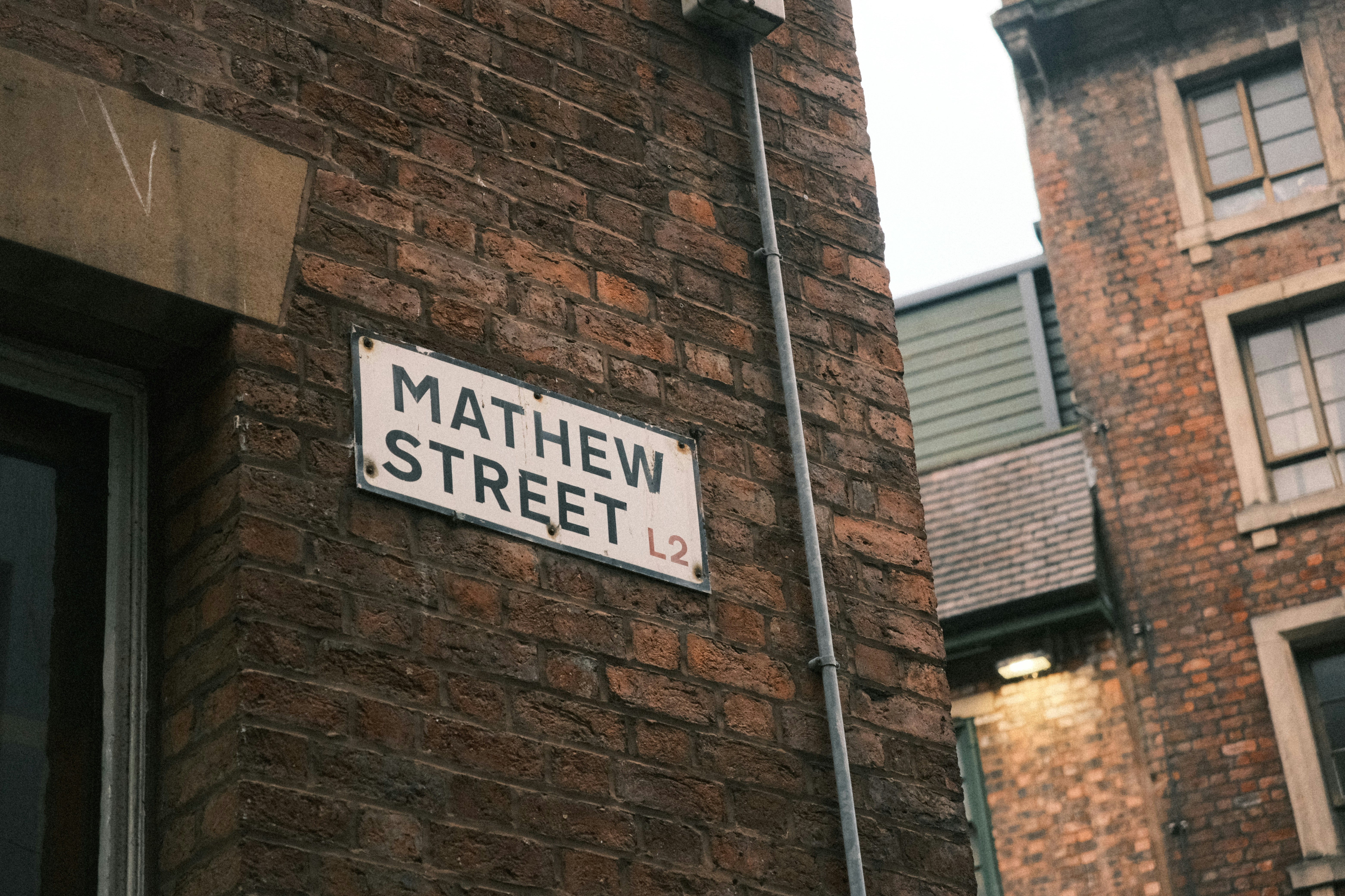 A street sign on the side of a brick building