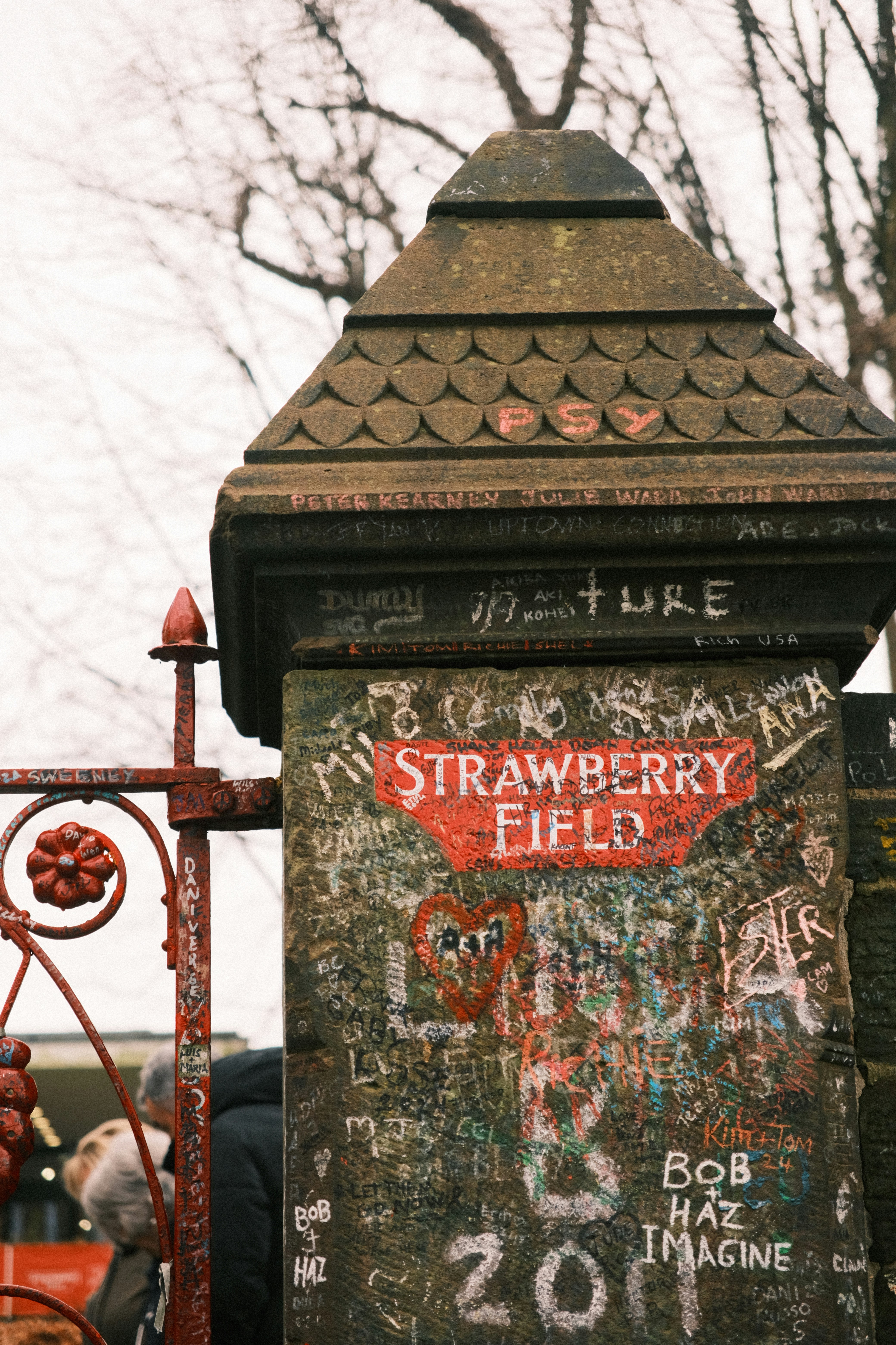 A rusted fire hydrant with graffiti on it