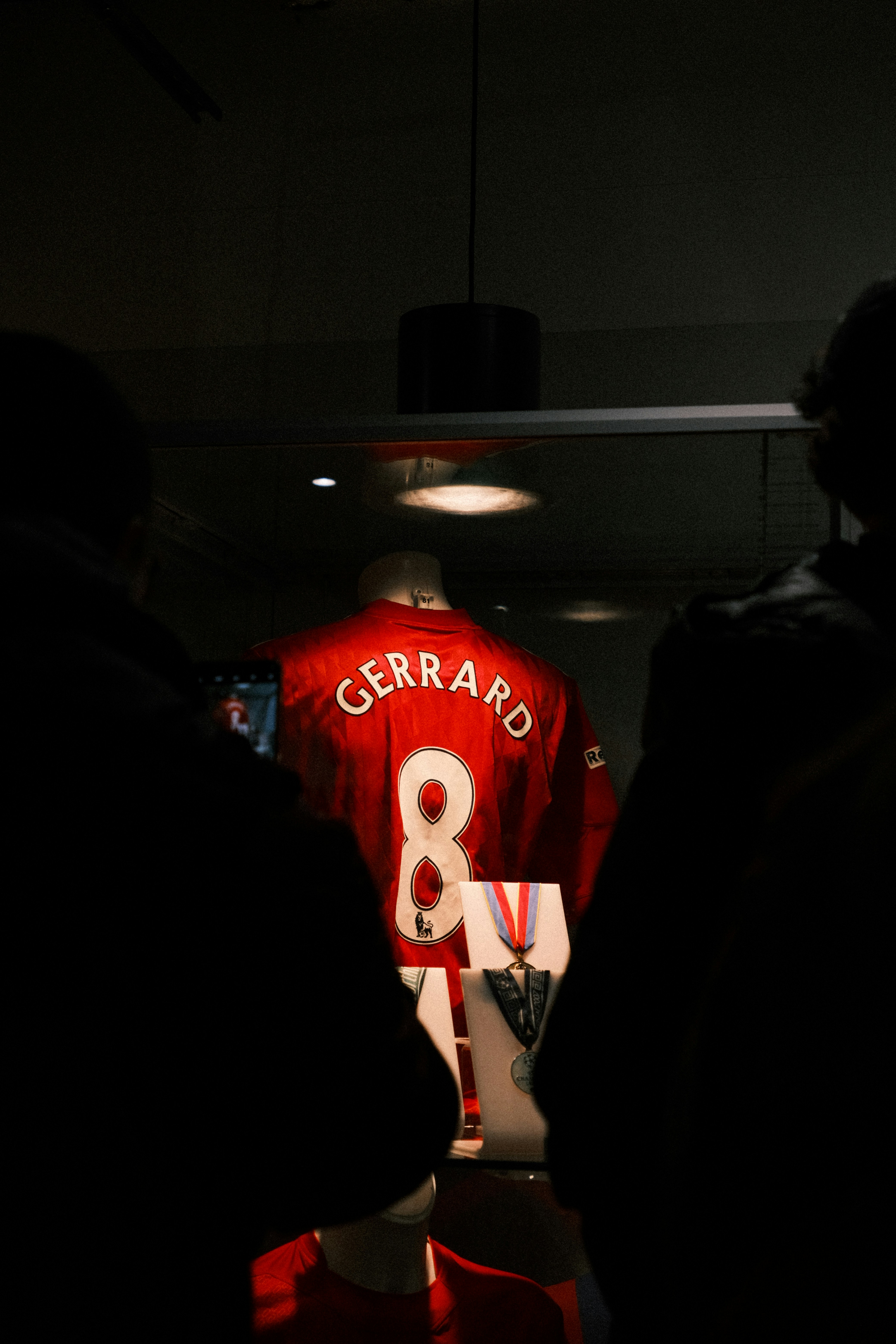 A group of people standing in a dark room