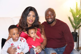 A man and woman sitting on a couch with two children