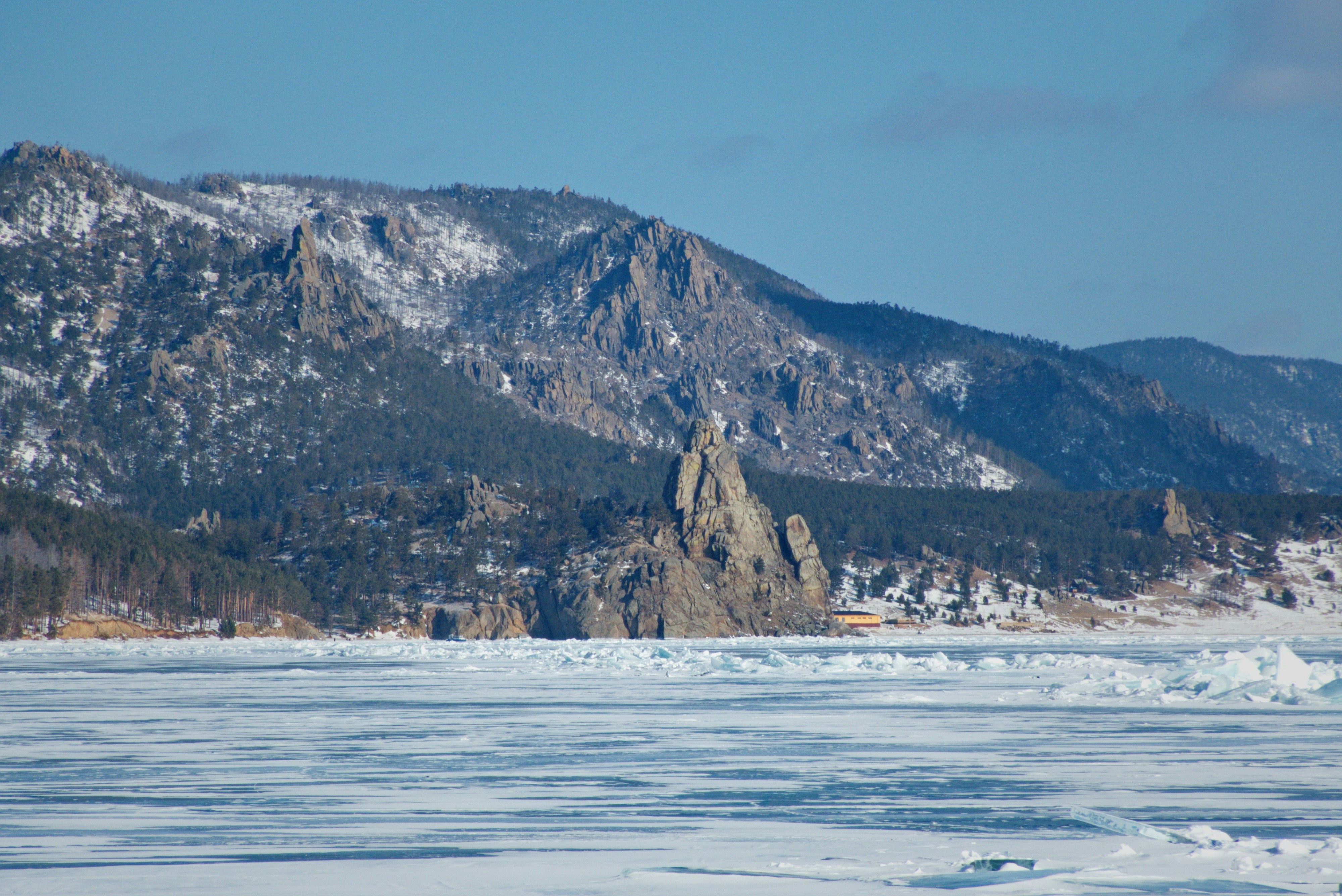 A man riding skis on top of snow covered ground