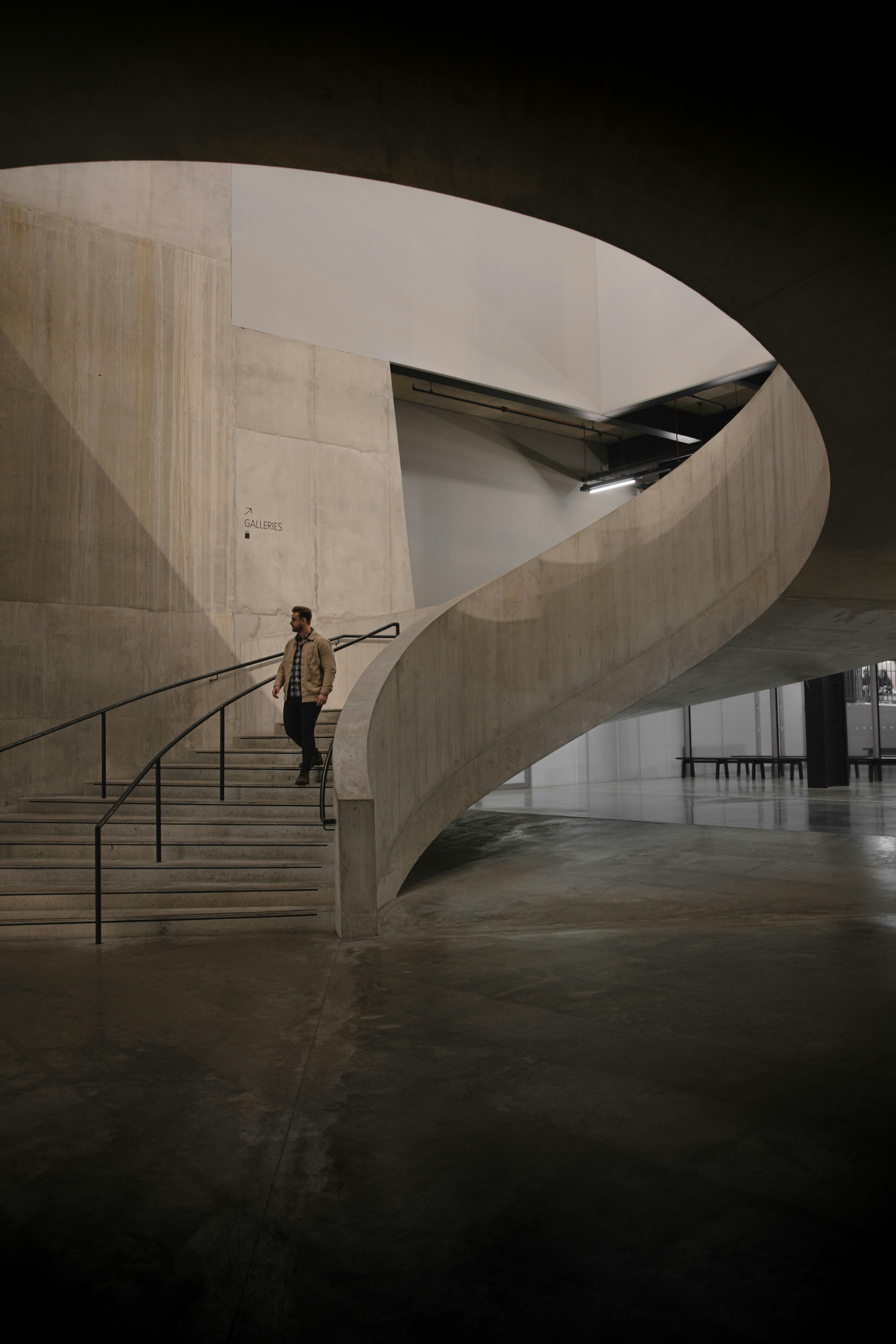 A man walking down a set of stairs in a building