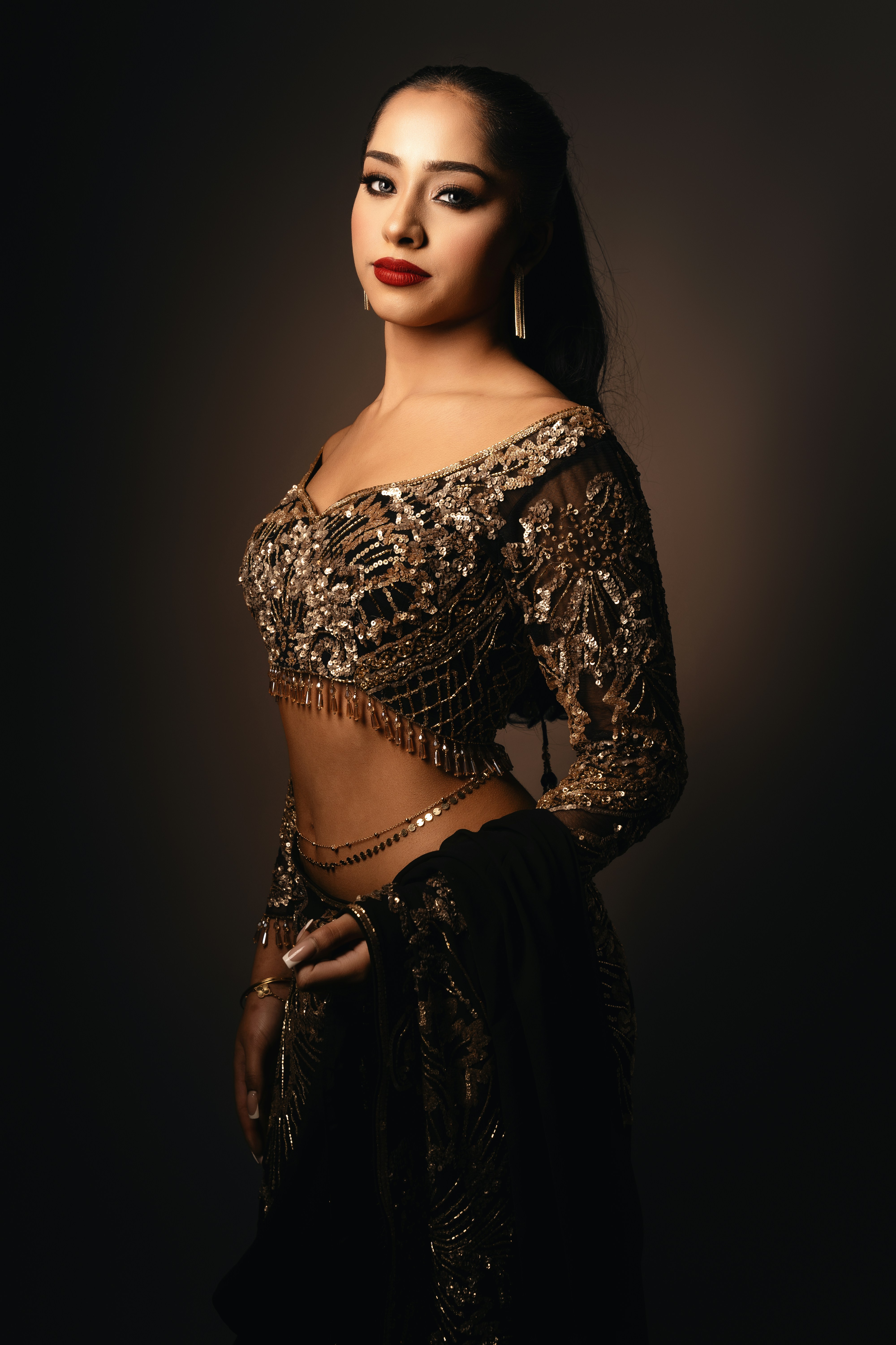 A woman in a black and gold outfit