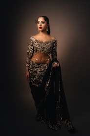 A woman in a black and gold outfit