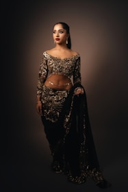 A woman in a black and gold outfit