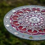 A red and white plate sitting on top of a green field