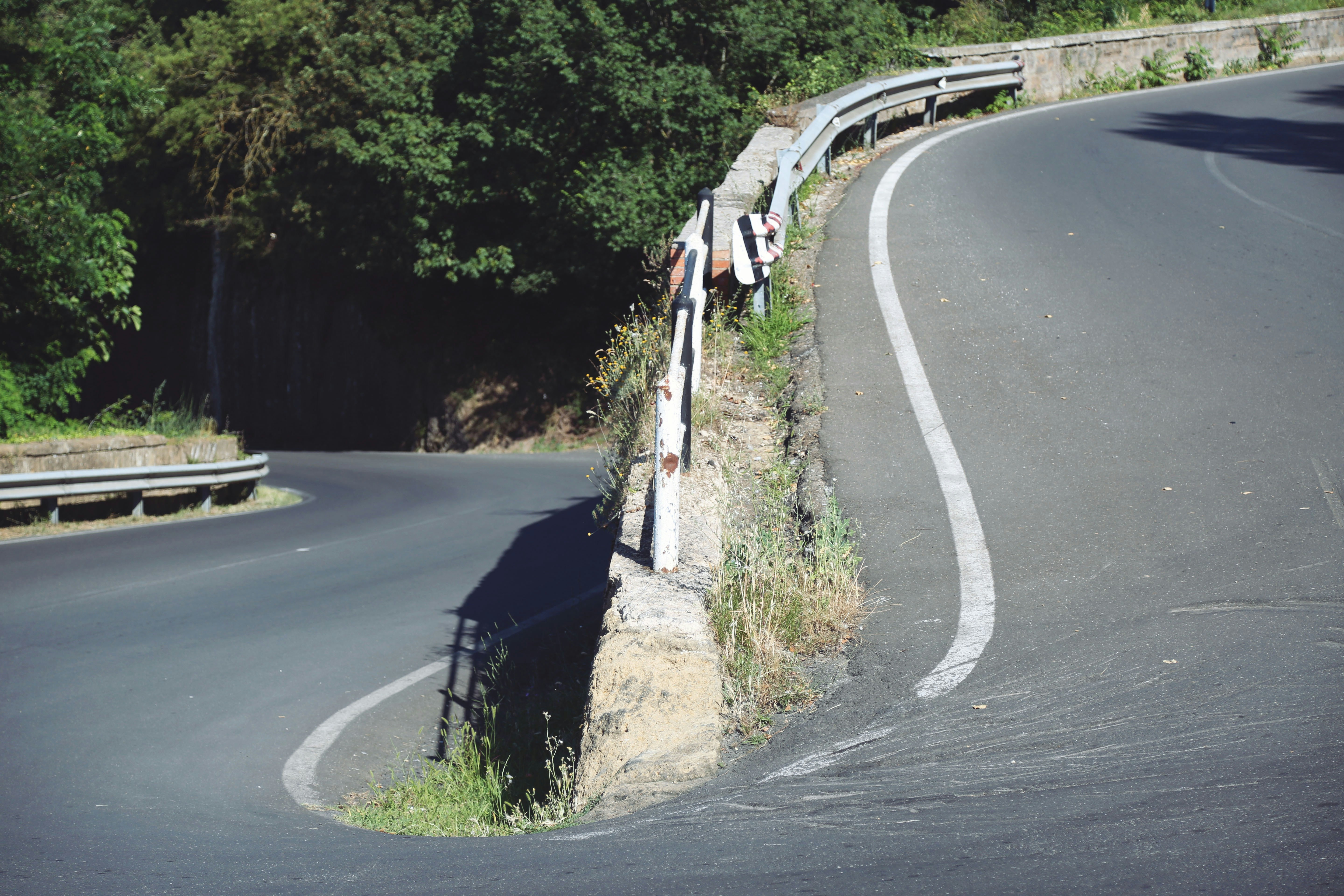 A curve in the road with trees in the background