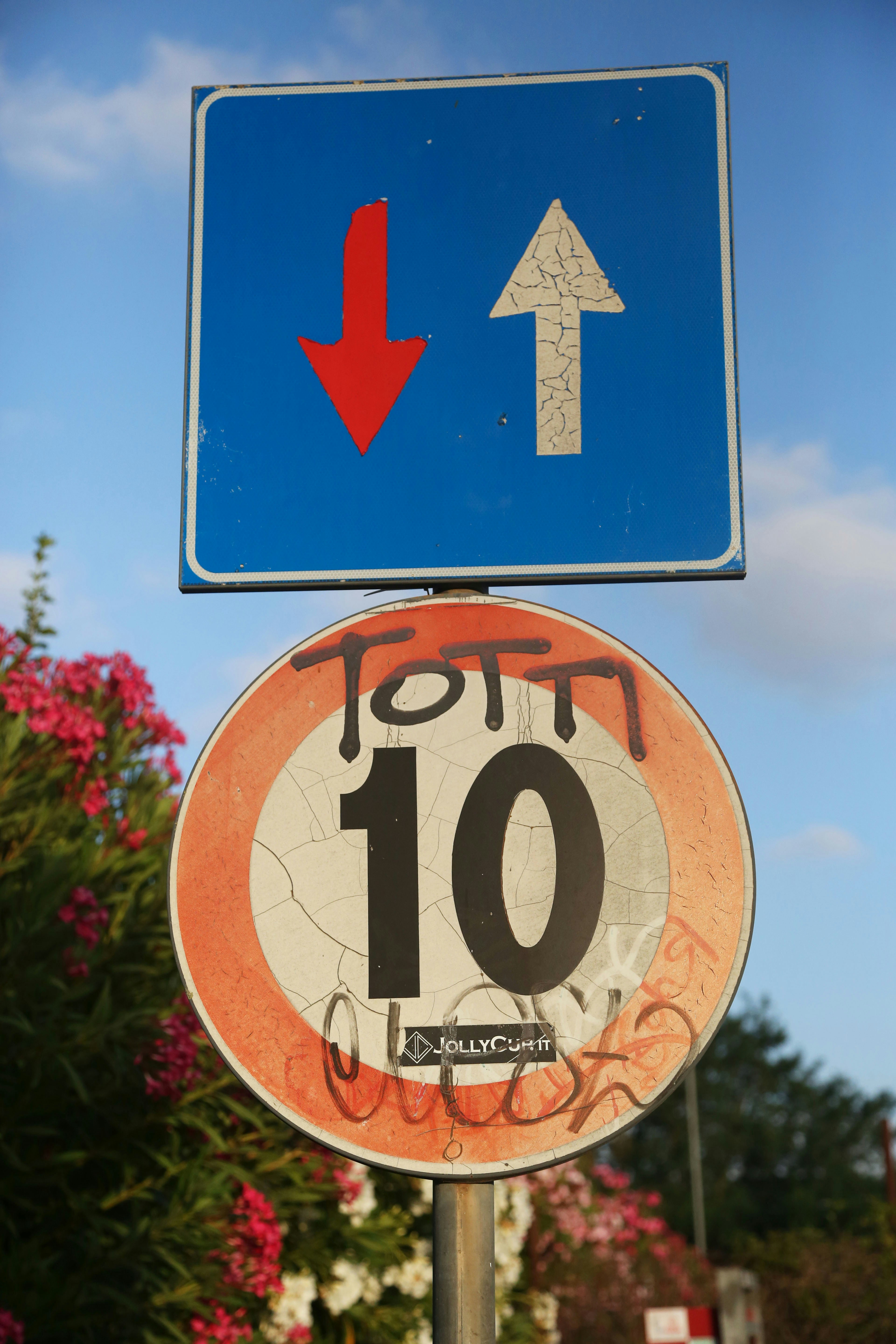 A close up of a street sign with a sky background