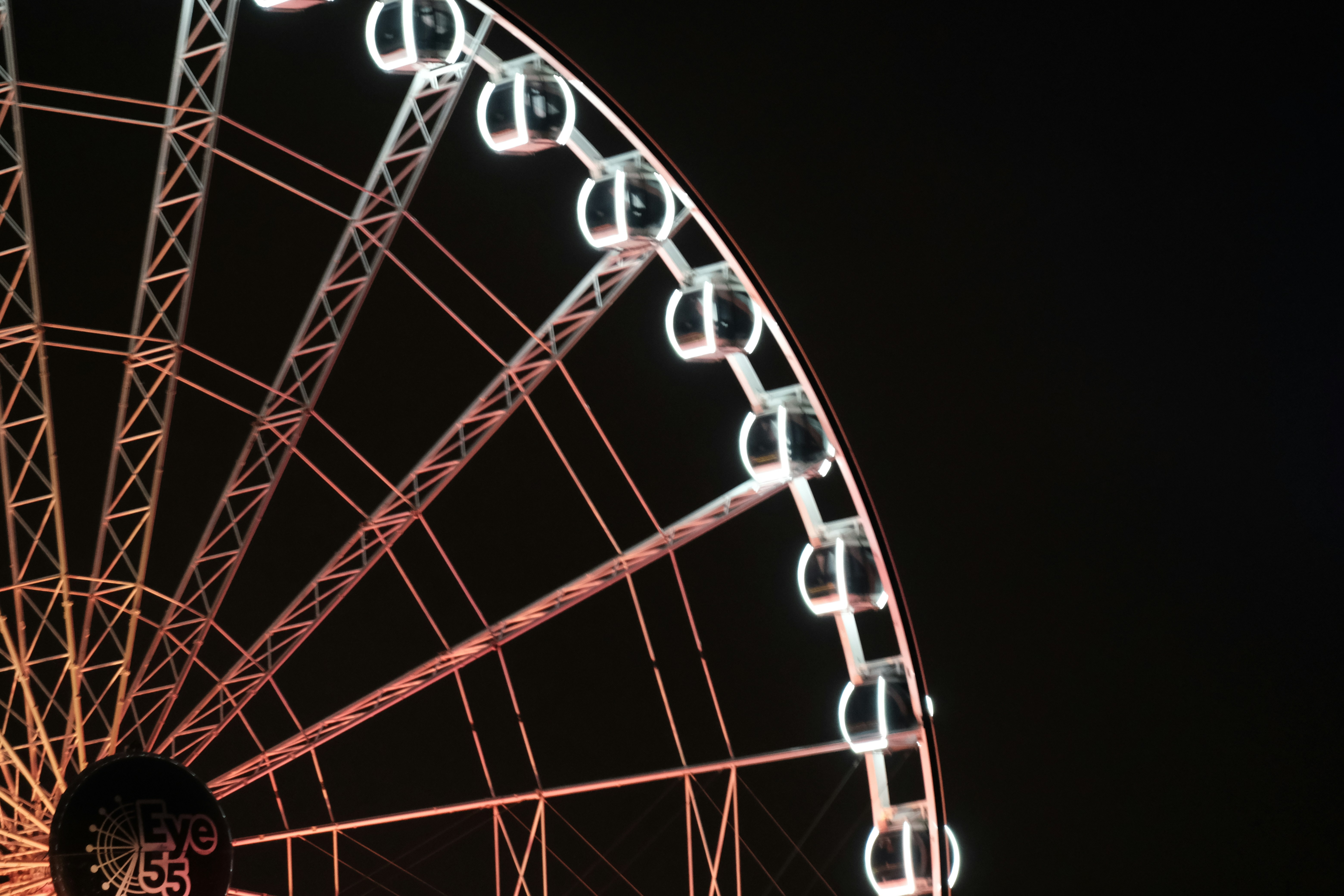 A ferris wheel lit up in the night sky