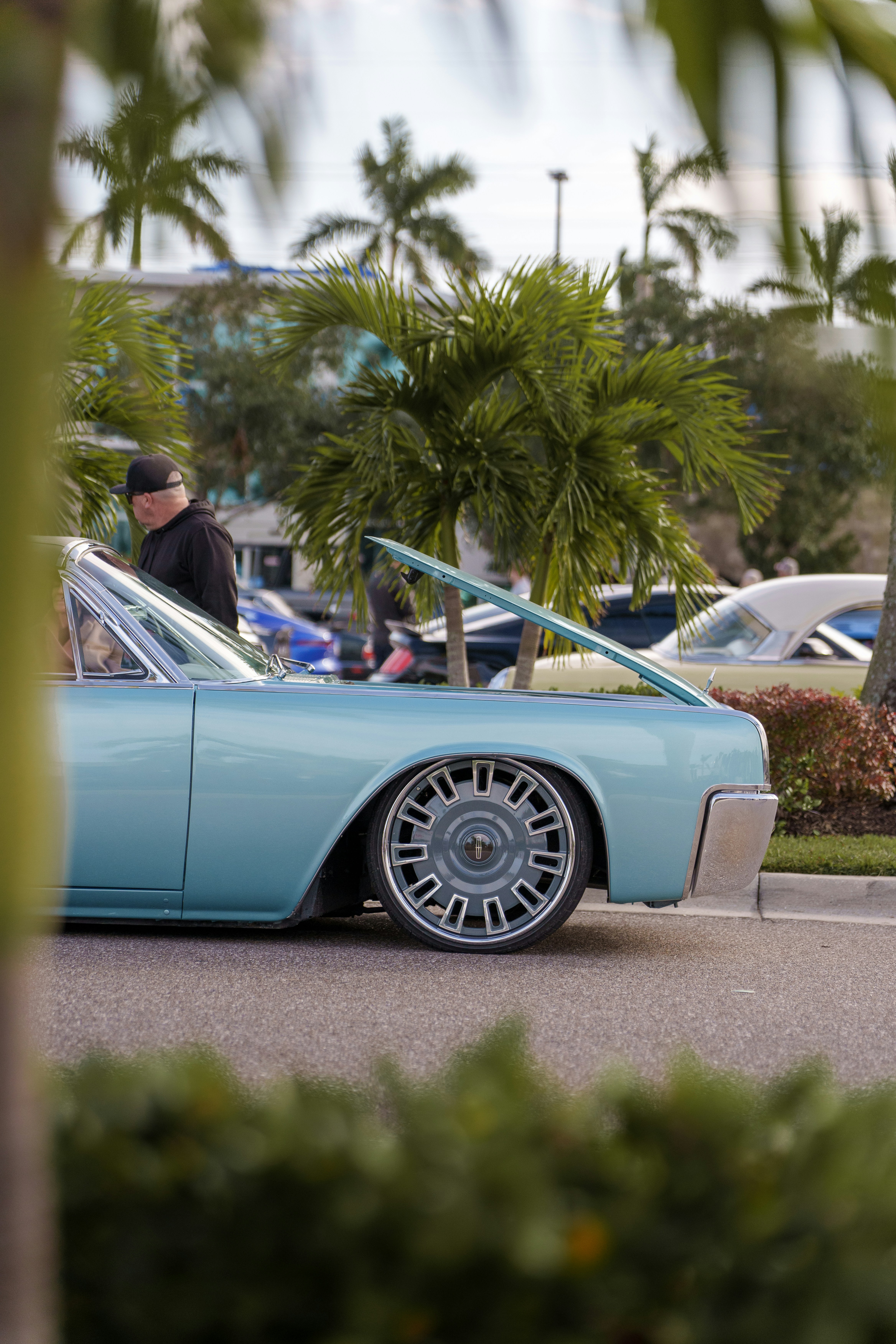 A blue car parked on the side of the road