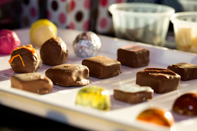 A tray of assorted chocolates sitting on a table