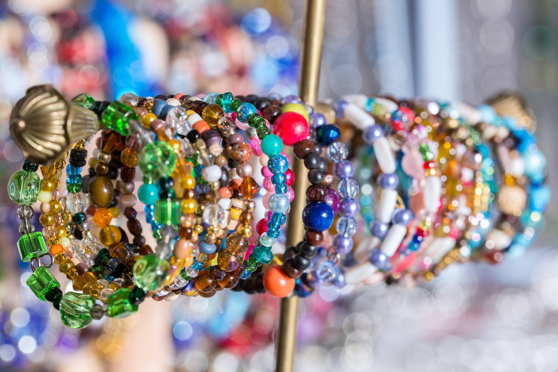 A bunch of bracelets that are on a stick
