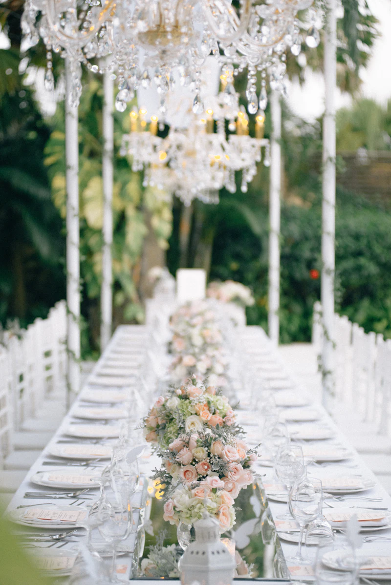 A long reception table under a chandelier