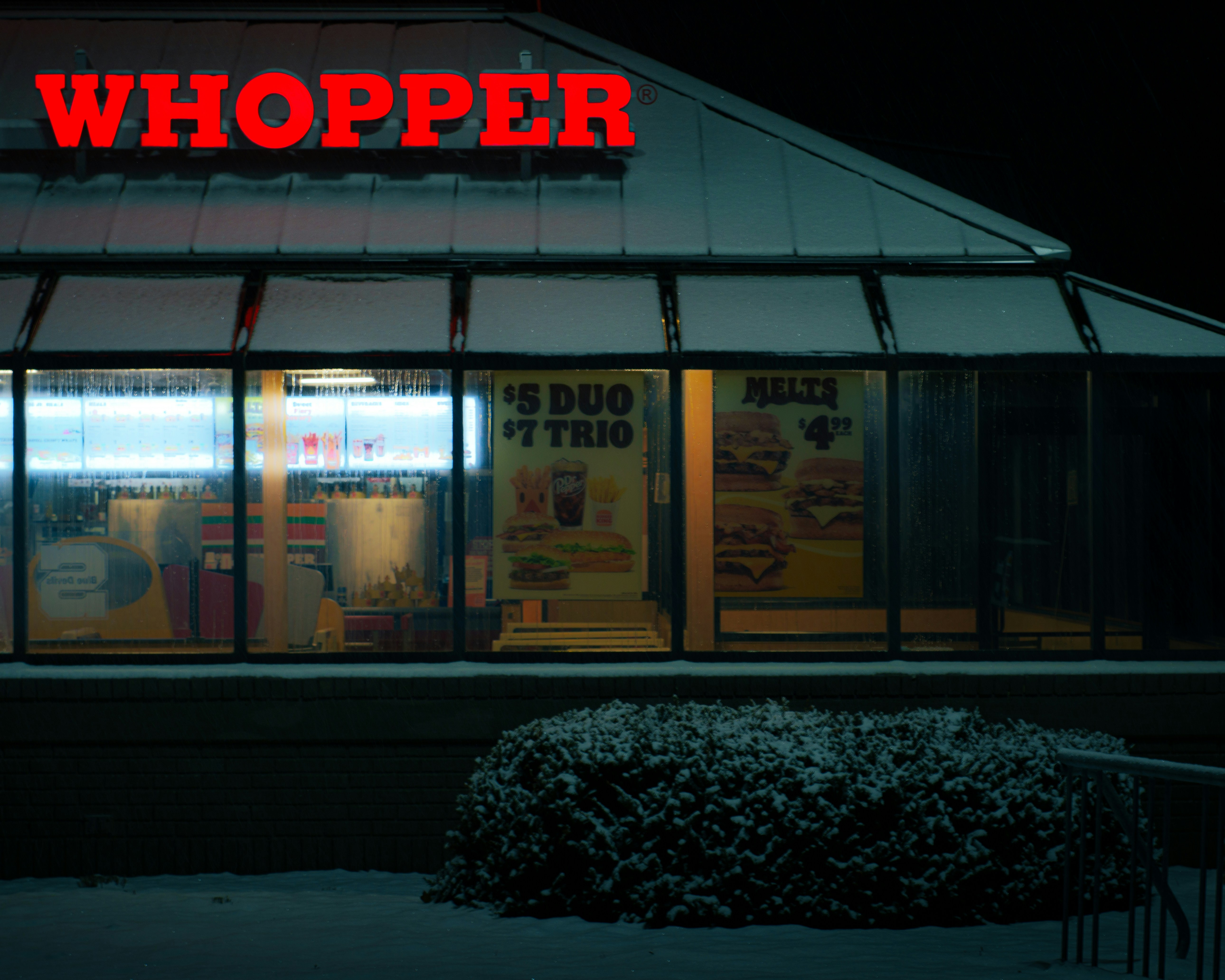 A store front at night with the lights on