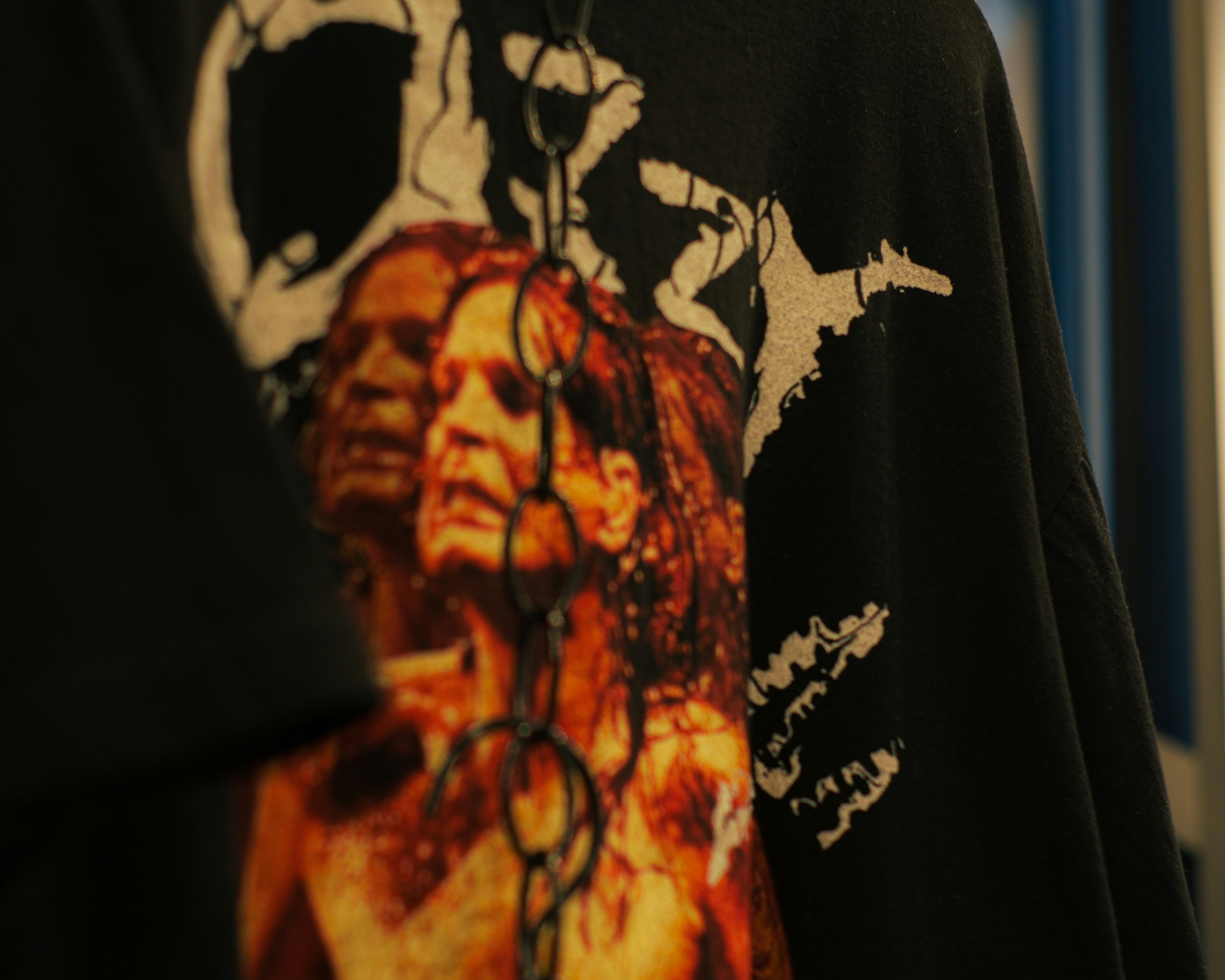 A man wearing a black shirt with a picture of a man on it