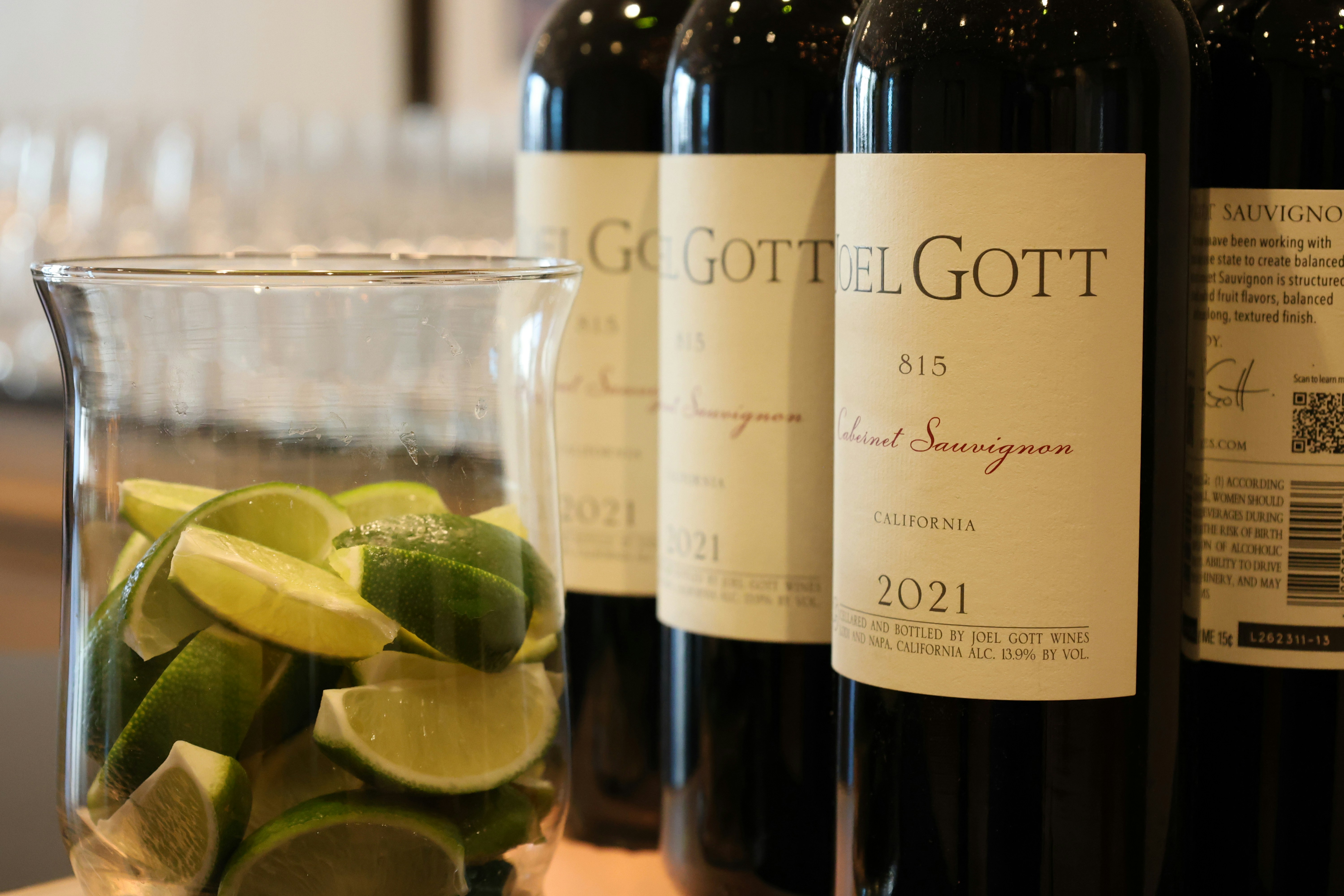 Three bottles of wine sitting on a counter