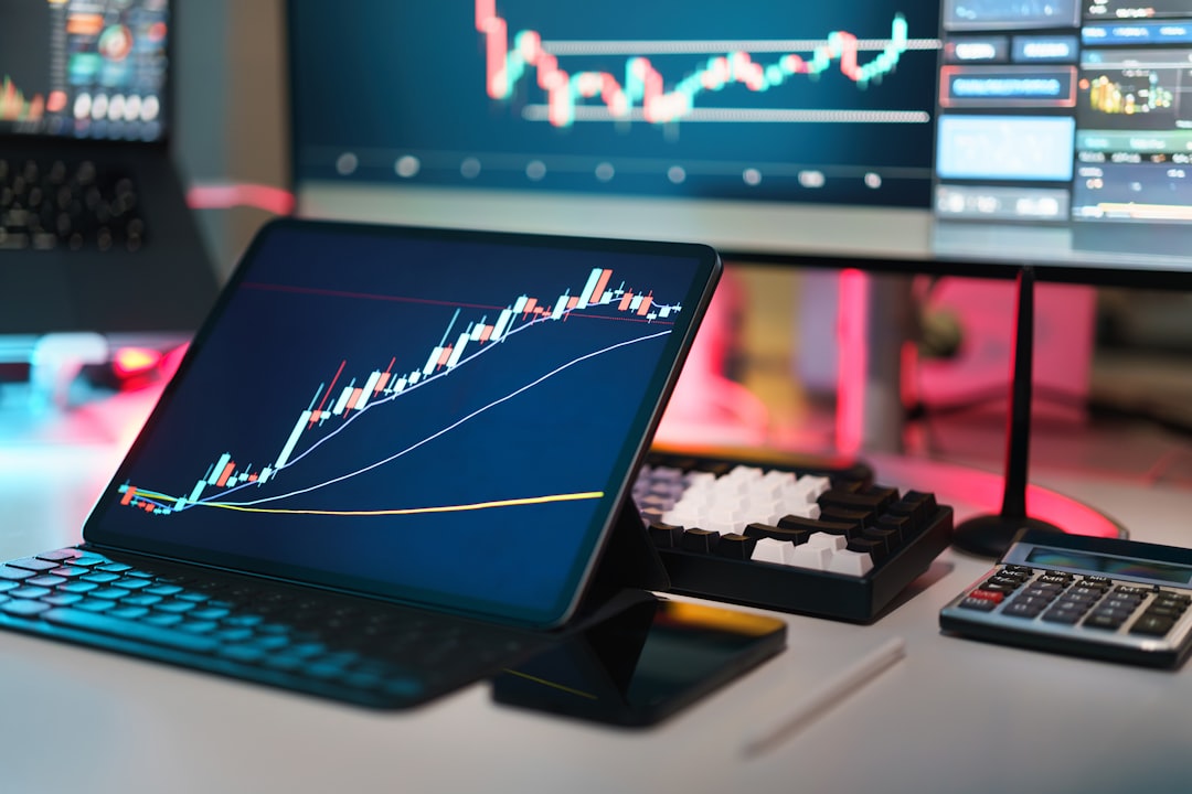 A laptop computer sitting on top of a desk, crypto currency finance analytics screen office space table computer displays