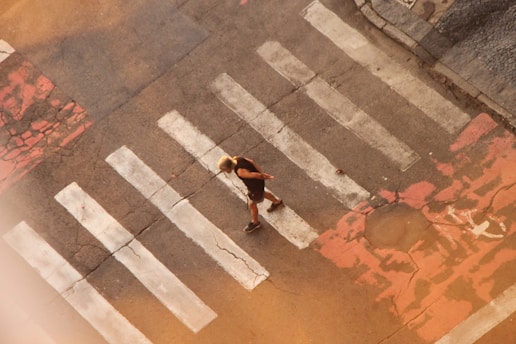 An aerial view of a person crossing a street