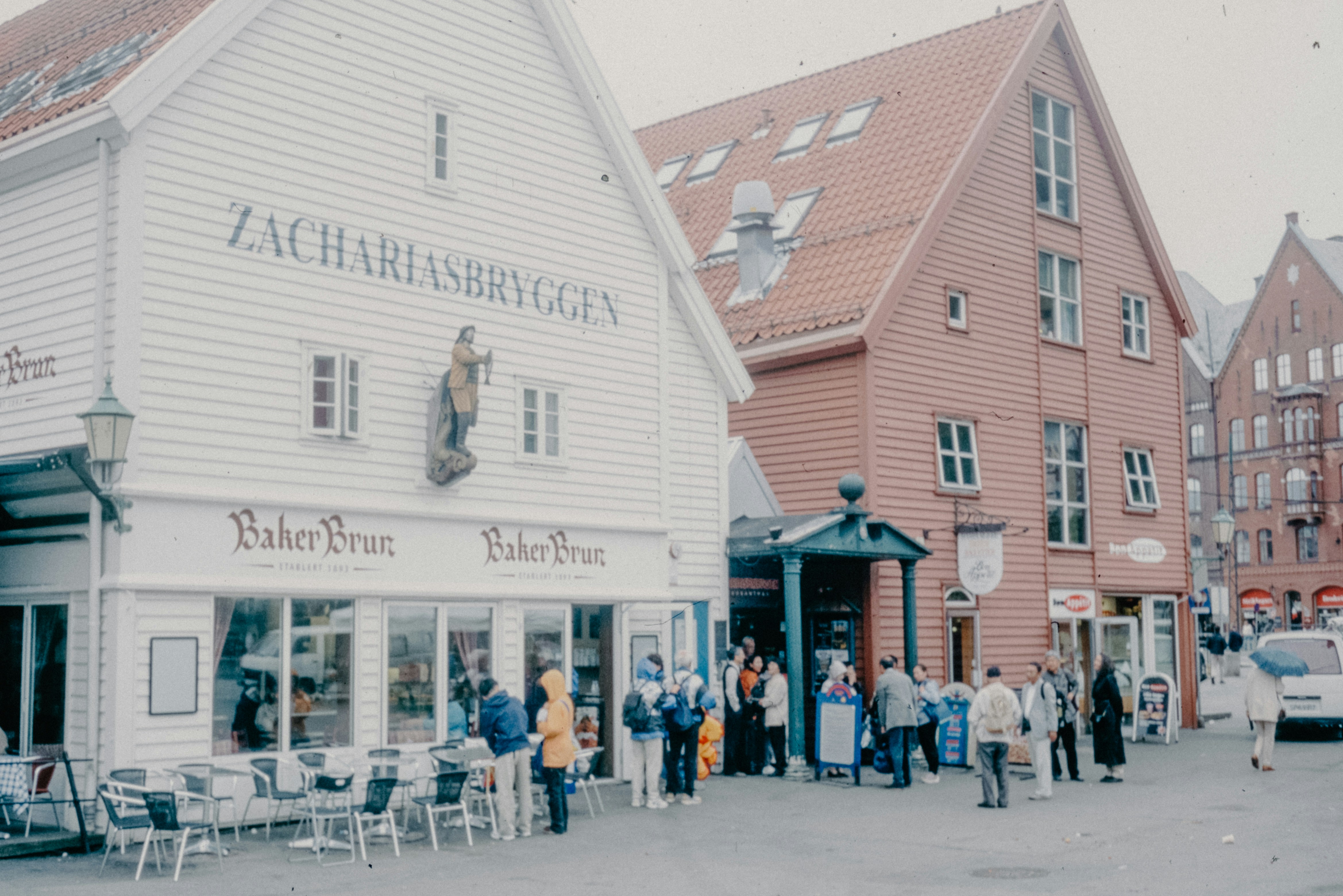 A group of people standing outside of a white building