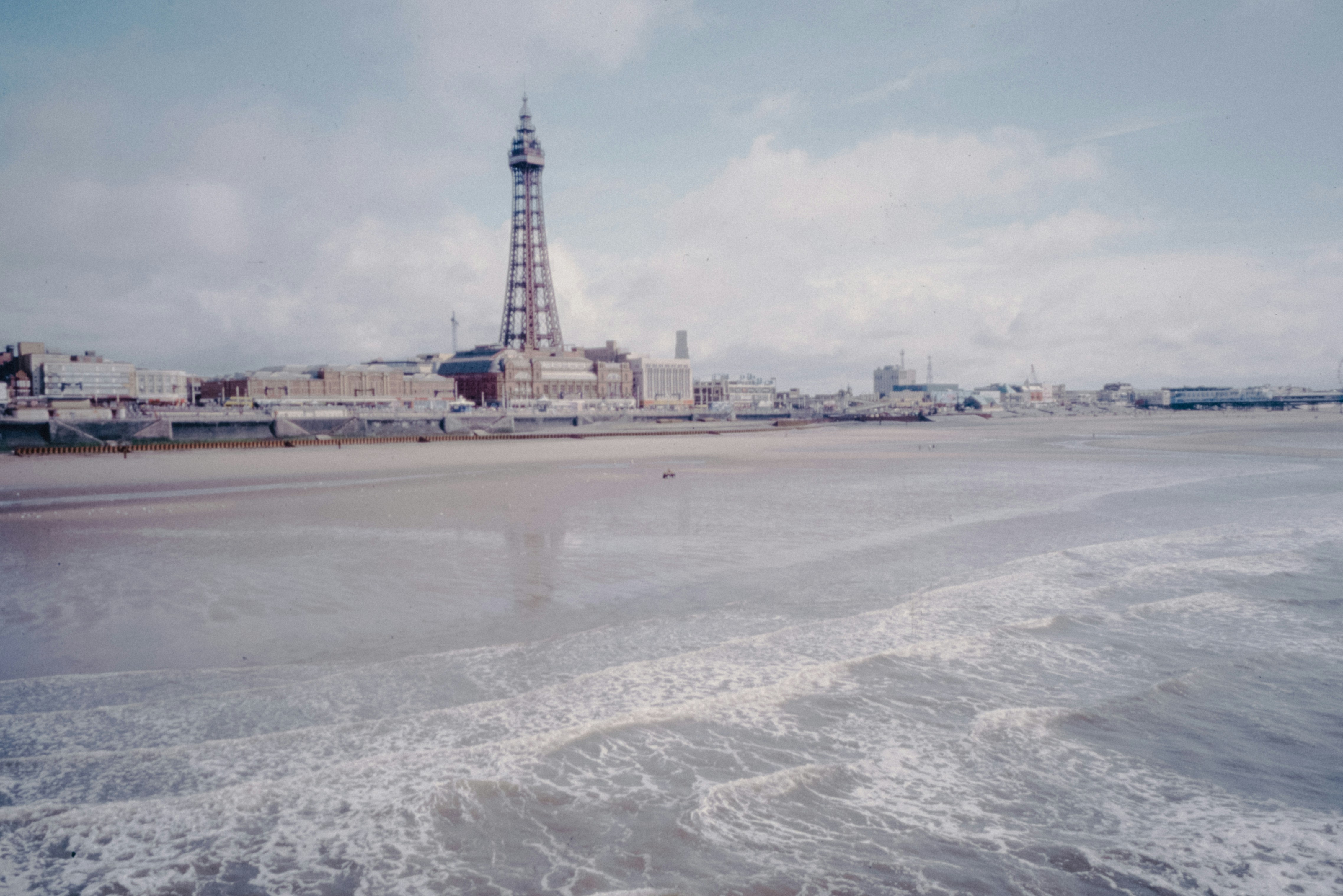 A view of a beach with a tower in the background
