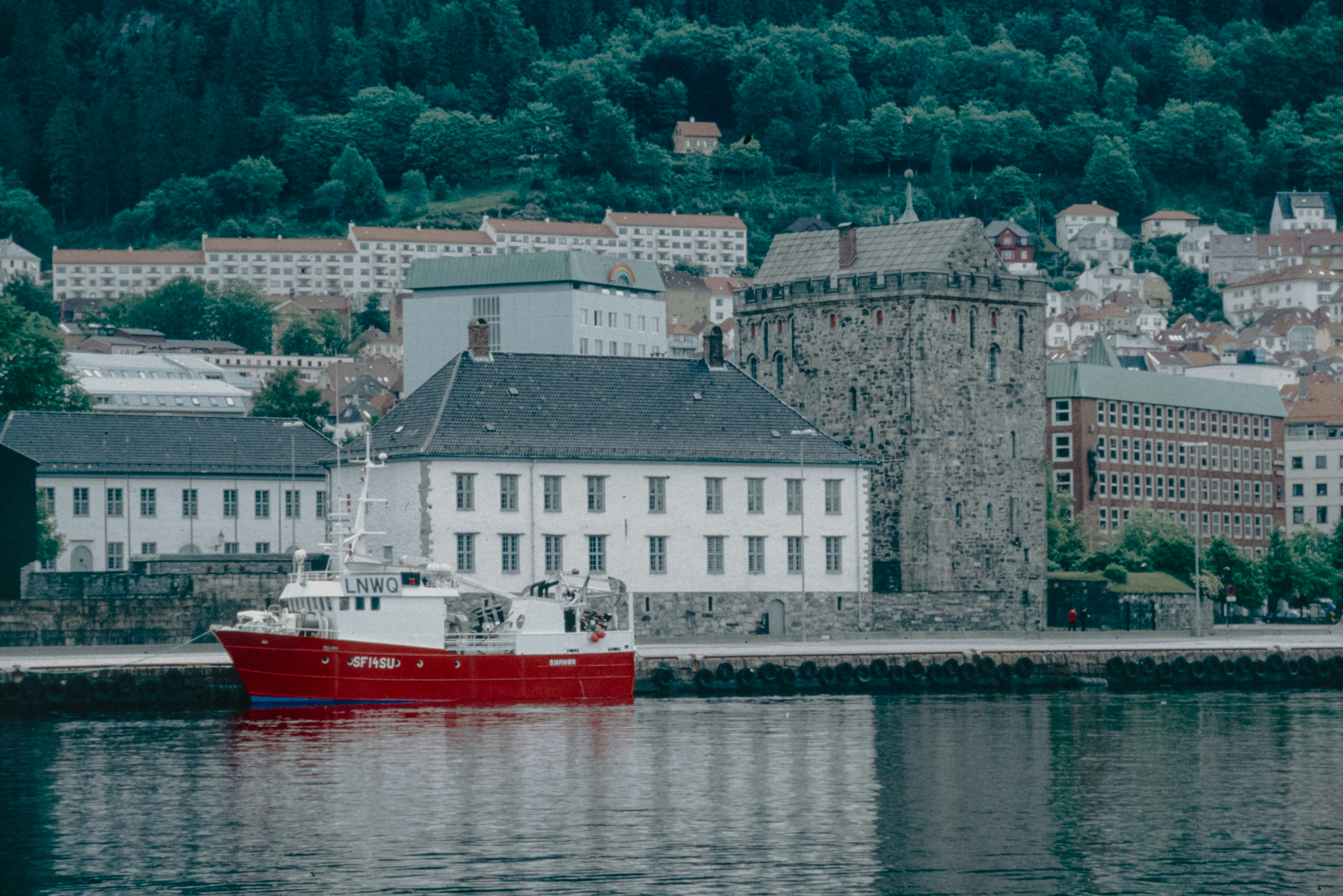A red and white boat in a body of water