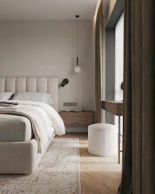 A bedroom with a large bed and a large window
