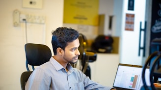 A man sitting in front of a laptop computer